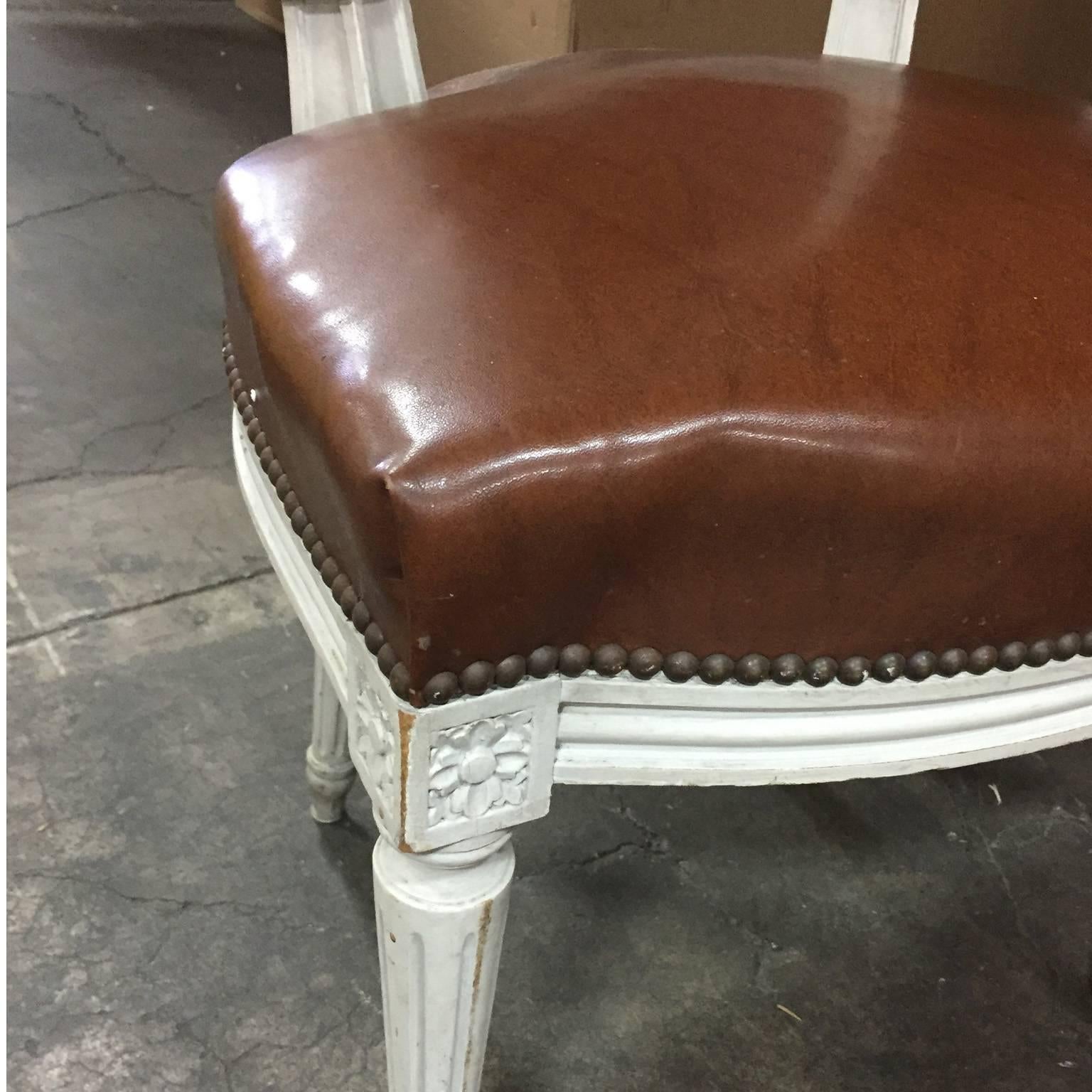 An absolutely stunning set in excellent condition throughout. Originally finished in an off-white, with some wear consistent with age. A gorgeous patina. Leather has been taken care of very well. Leather upholstered on seat and back of chair as seen