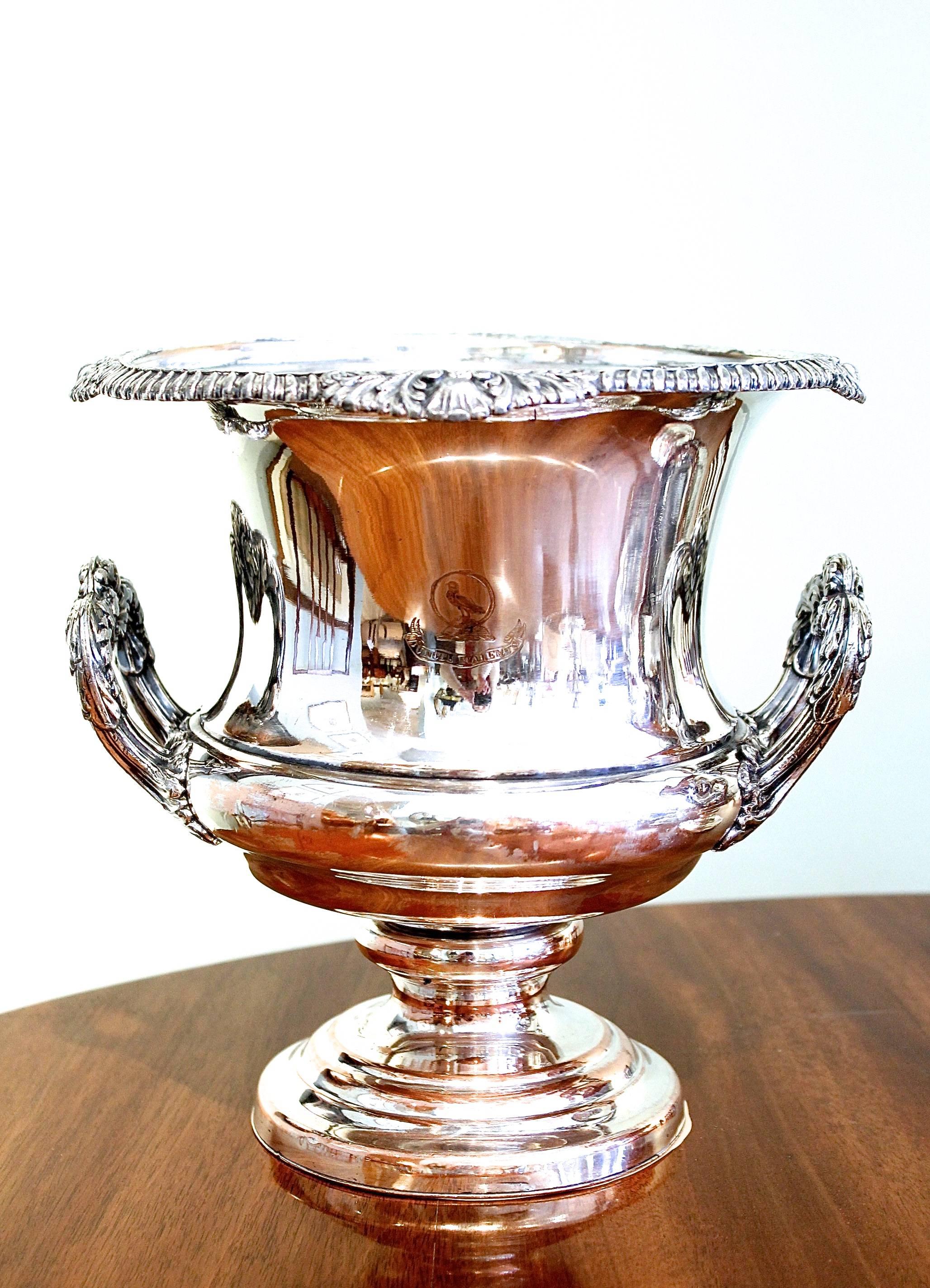 A pair of 19th century English Champagne buckets with armorial engraving on both sides, one side with a boar’s head and “Semper Fidem” “(always faithful”) and the other side bearing an engraved bird along with the Walker family motto “Juncti