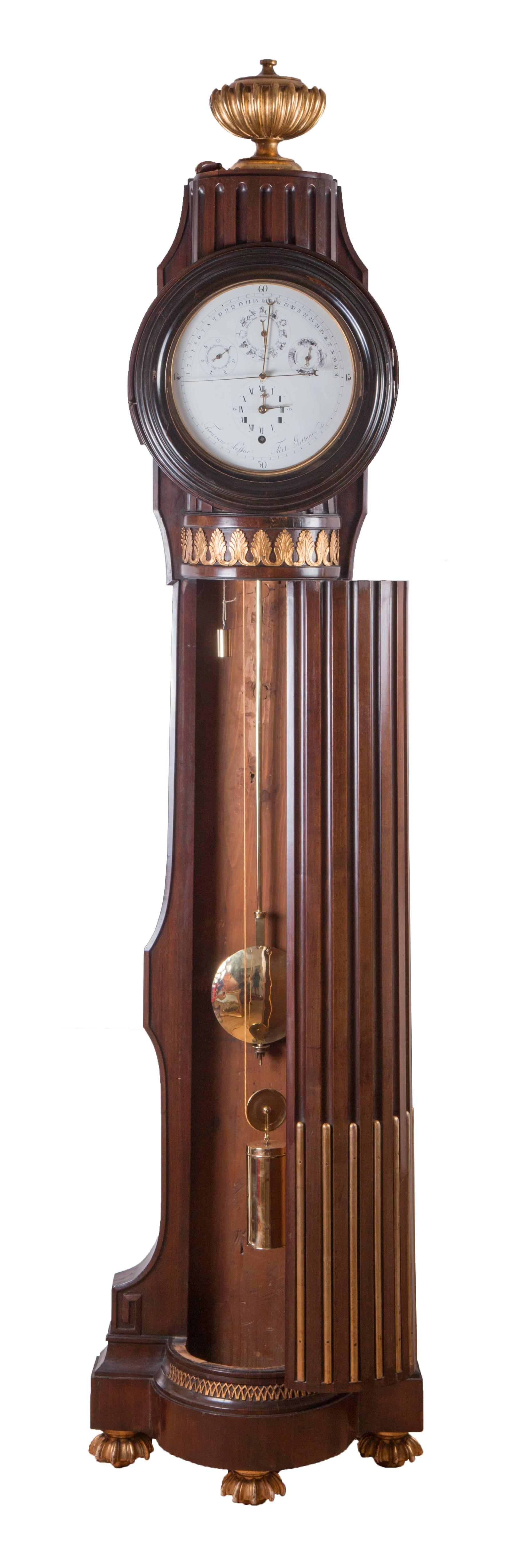 Floor standing clock signed: "Franciscus Seiffner fecit Pesthini."
Height: 223 cm, duration: Eight days
Mahogany veneered case in the form of a fluted pillar, carved and gilt mouldings and crest, enamel dial, center sweep second's hand,