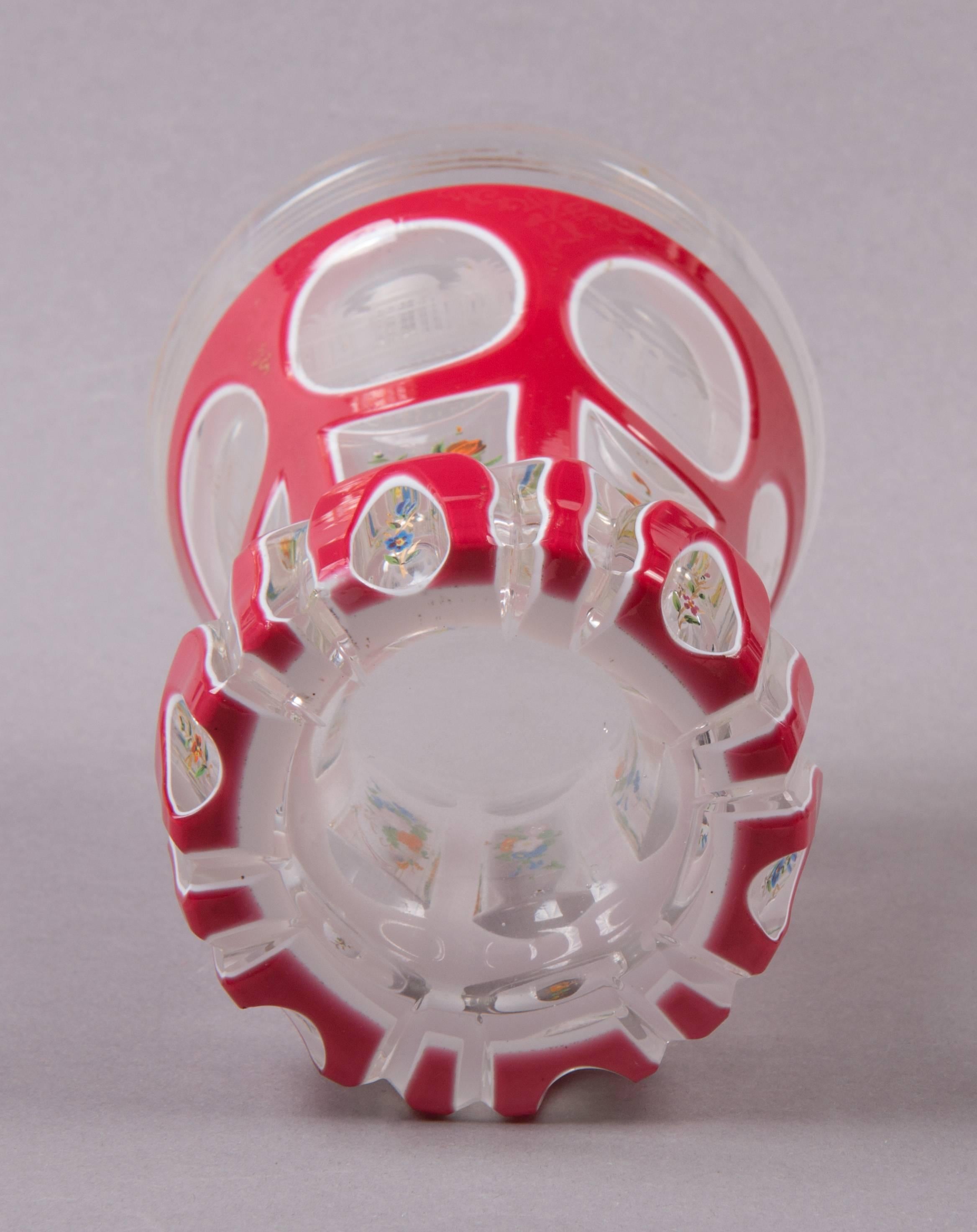 Colourless glass with pink and white overlay. With flowerpaintings and six medallions of topographic places like “Kreuzbrunn”.

 