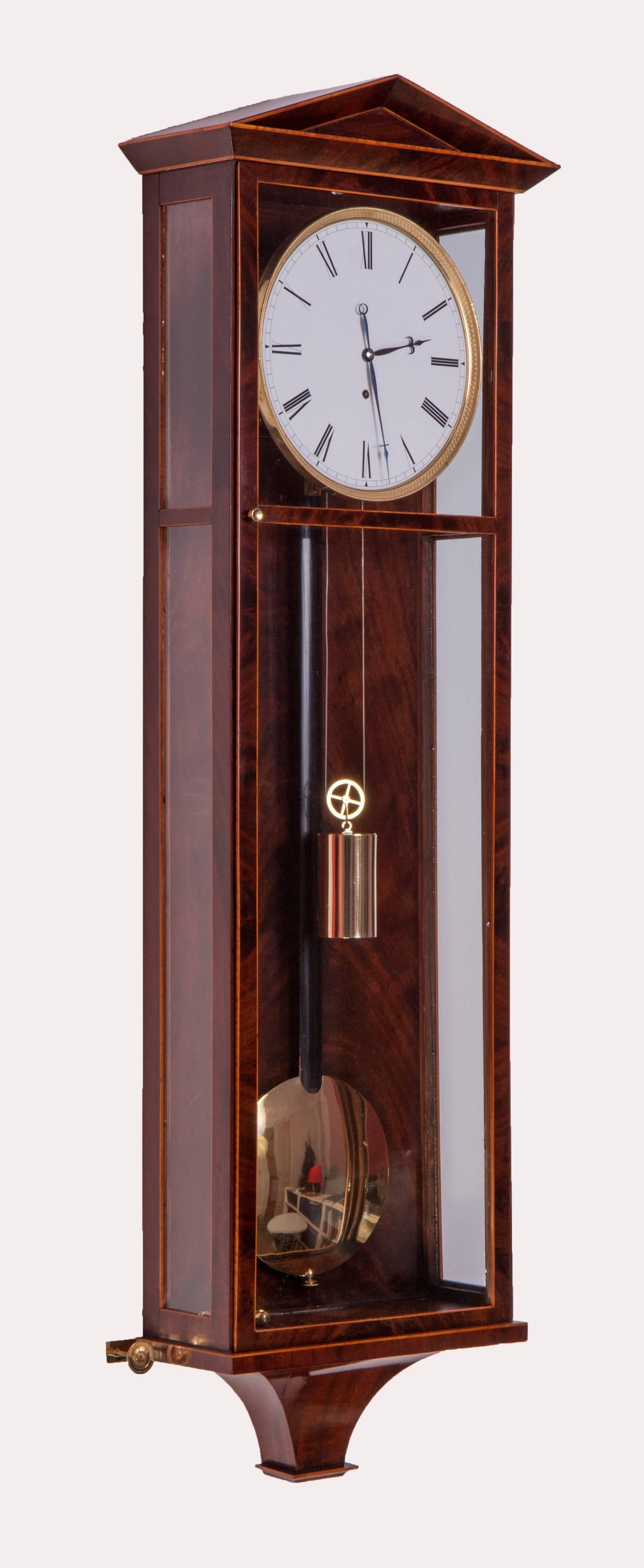 Mark on the plate: “AP”: Anton Pohl?, Vienna circa 1830
Length: 88 cm, duration: eight days
Mahogany veneered case with maple stringing, enamel dial, blued steel hands, engine turned gilt bezel, deadbeat escapement, spring suspension, wood rod