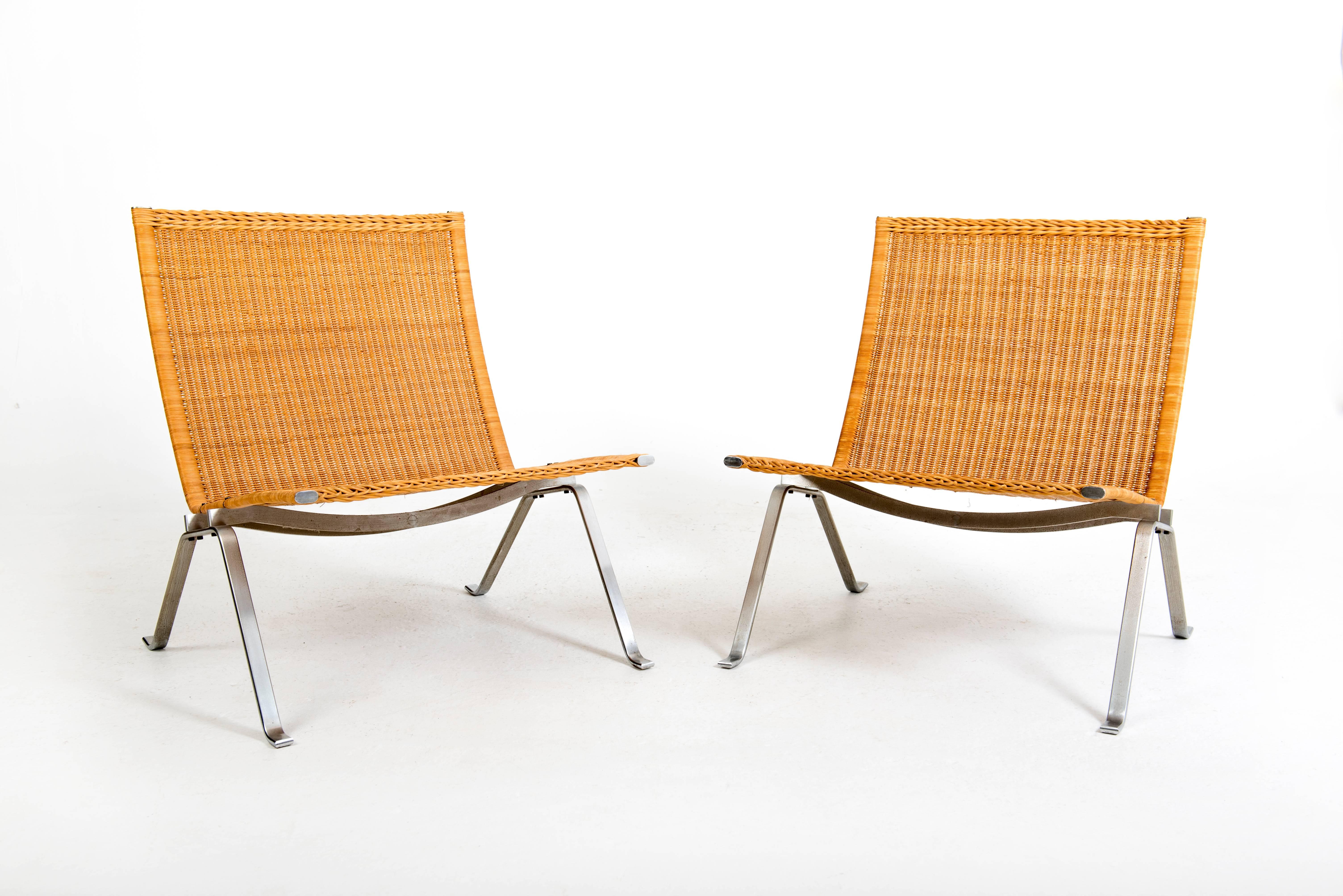 Poul Kjærholm 

PK-22.

Pair of easy chairs with steel frame, seat and back with cane. 

Made and stamped by Fritz Hansen.