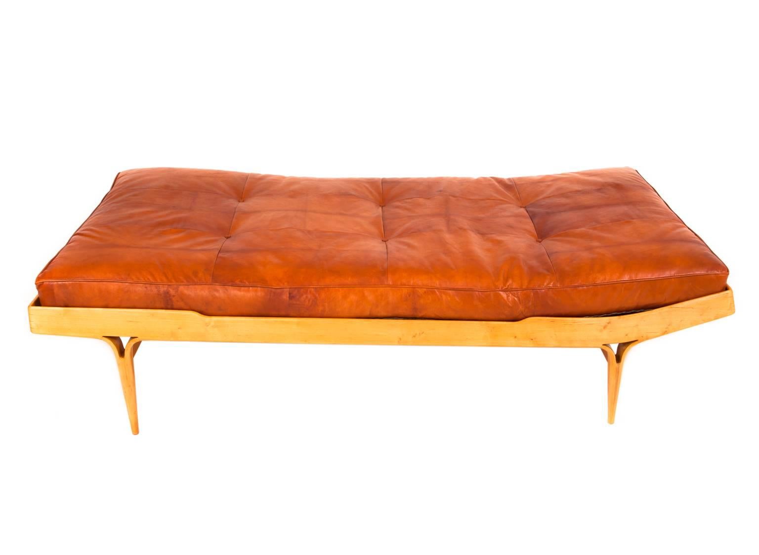 Bruno Mathsson, 

Berlin. 

A birch daybed with moulded tapering legs, loose matress with Niger leather. Stamped Firma Karl Mathsson

Made in Värnamo, Sweden, 1966 

 