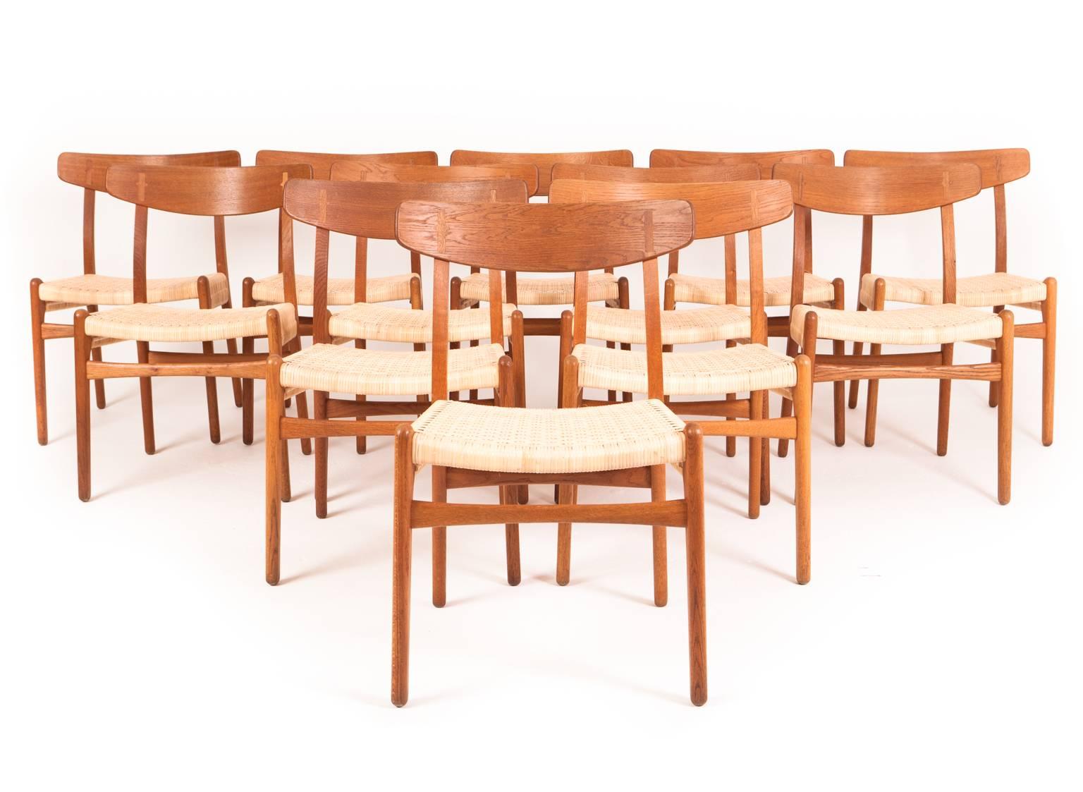Hans J. Wegner

Model CH 23 

Set of 12 oak chairs, seats with woven cane. 

Designed 1950
Manufactured by Carl Hansen & Son, Odense.