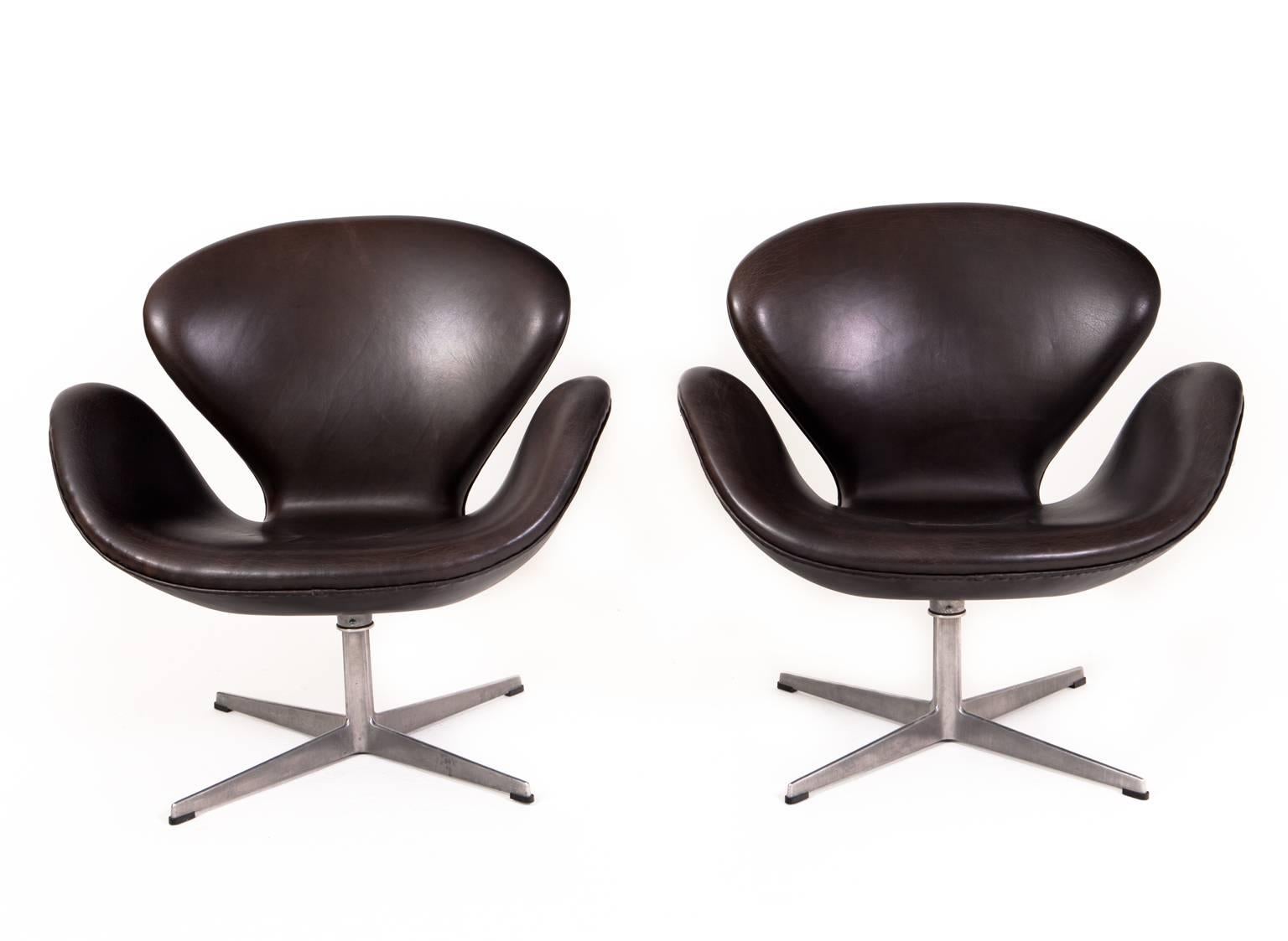 Arne Jacobsen

The swan. A pair of lounge chairs with patinated black leather, swivel four-star aluminium foot. 

Produced by Fritz Hansen 
Designed 1957-1958 for the Hotel Royal in Copenhagen.