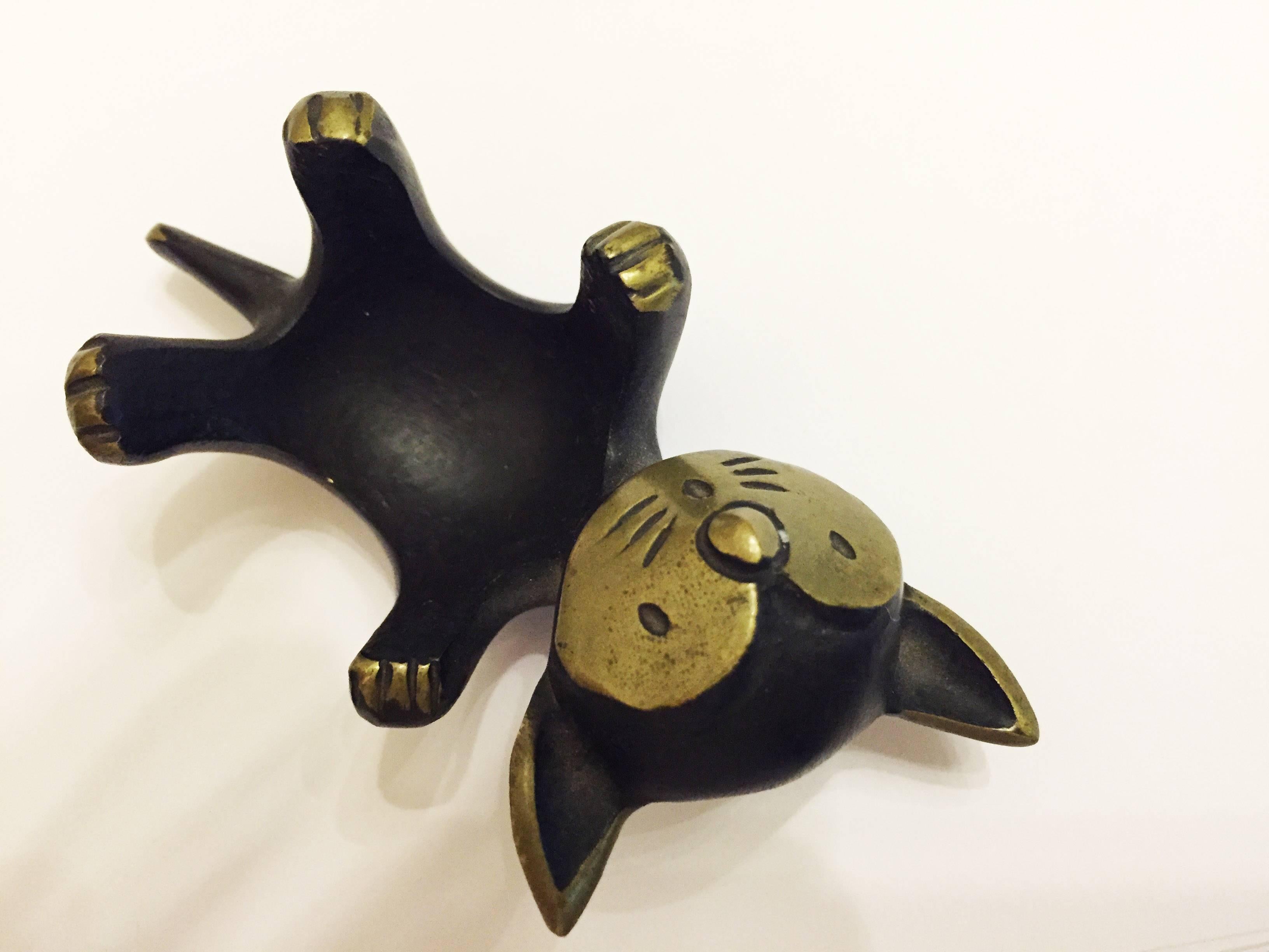 Designed by Walter Bosse for Hertha Baller Austria in the 1950s. Blackened brass cat, laying on it's back, possibly an egg cup, signed Baller Austria on the base, 9 cm long.
     