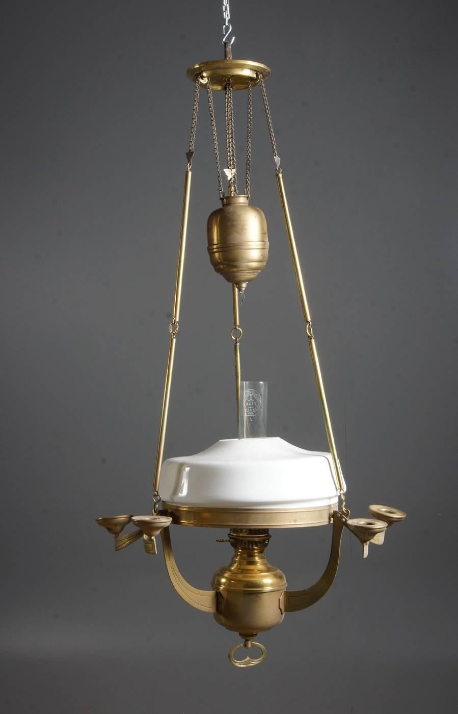 Large Art Nouveau brass hanging kerosene lamp from 1890-1900.
Three foot chain and canopy with opaline glass.
With light arms for six candles. Cup with notch.
 Measures: Height 105cm, diameter 57cm.

 