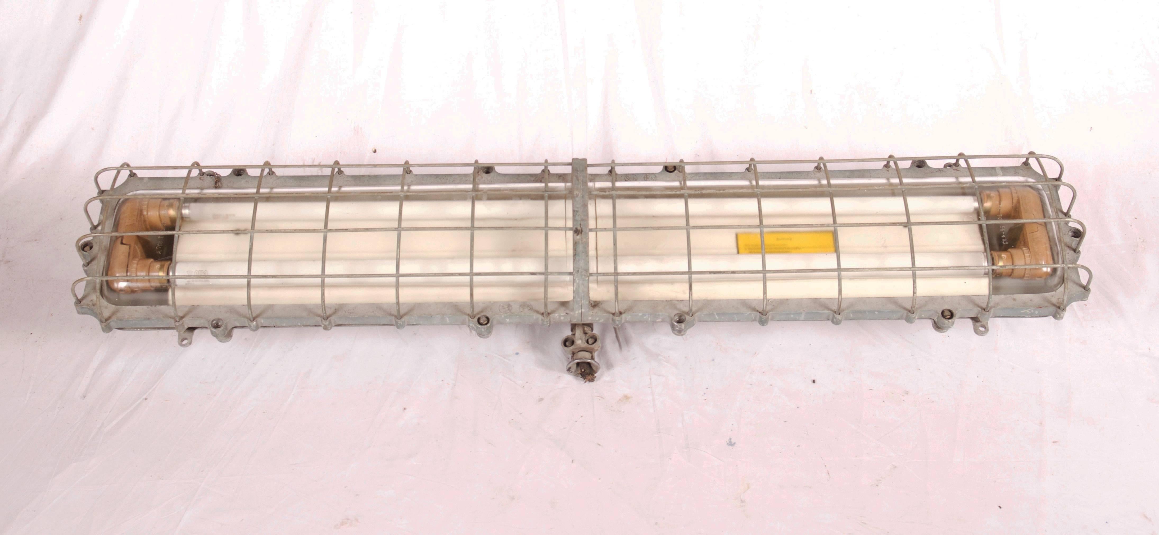 Heavy cast iron with glass and steel grid made in Germany in the 1970s.
Powered with two 120 cm (47,24inches) long tube lights.