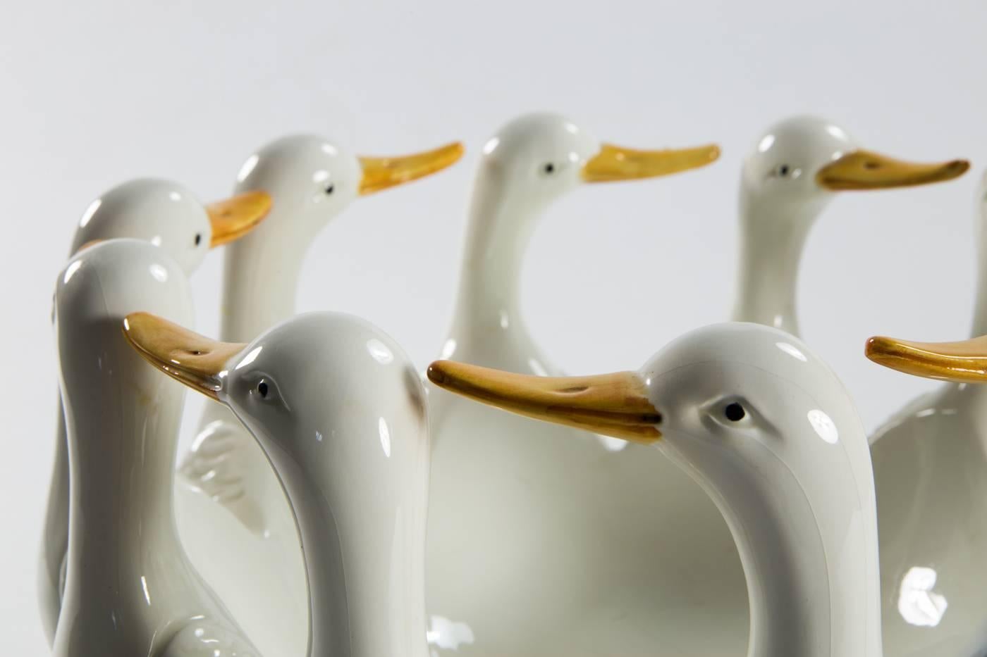 Round fruit bowl / goose dish, body with a gloss glaze. Bowl in the form of a row running geese. 
Dimensions: 24 cm H., DM 34 cm. 
In the middle with slight cracks in the glaze.