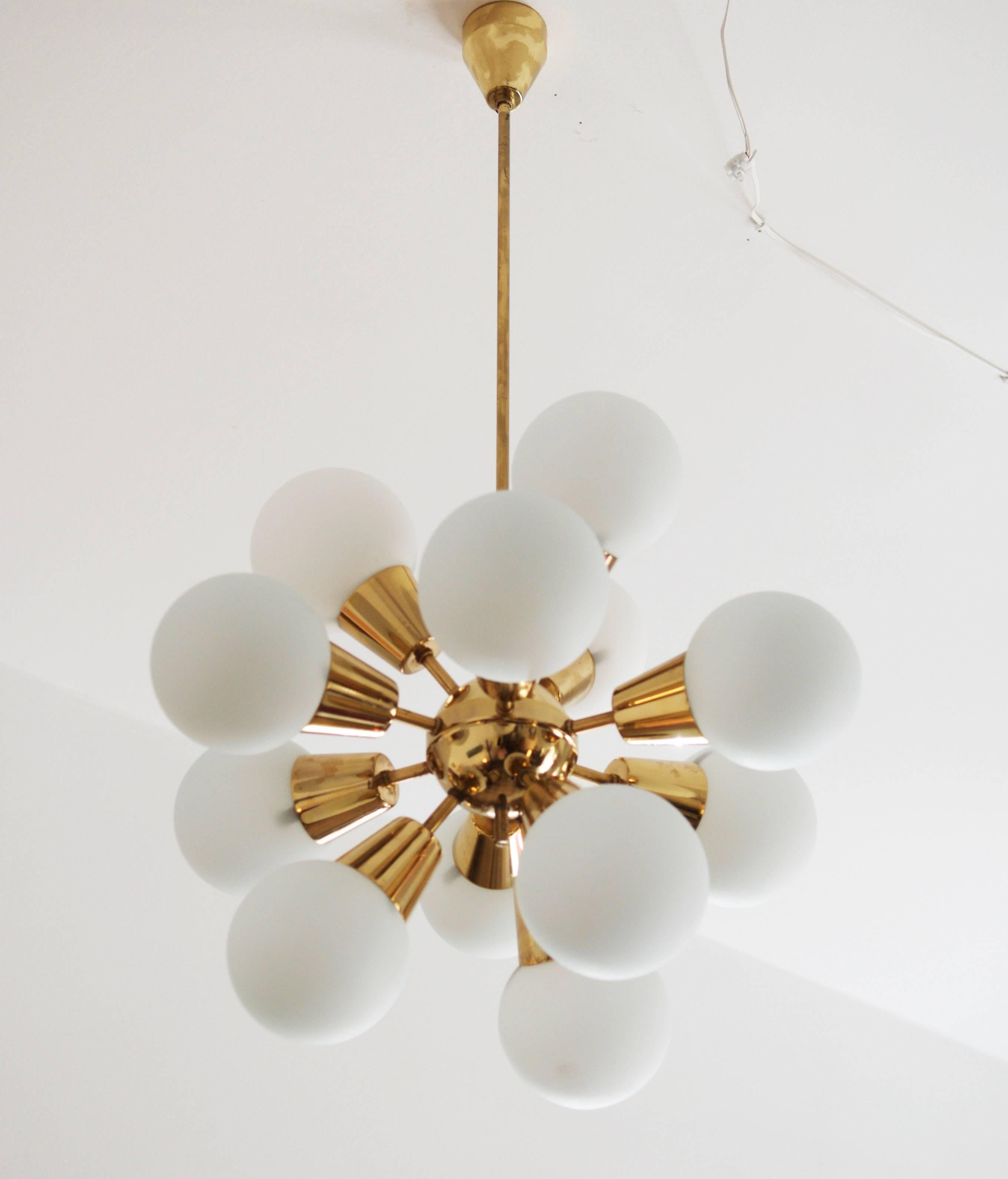 Brass construction with 12 opaline glass shades fitted with E14 bulbs. Made in the 1970s.