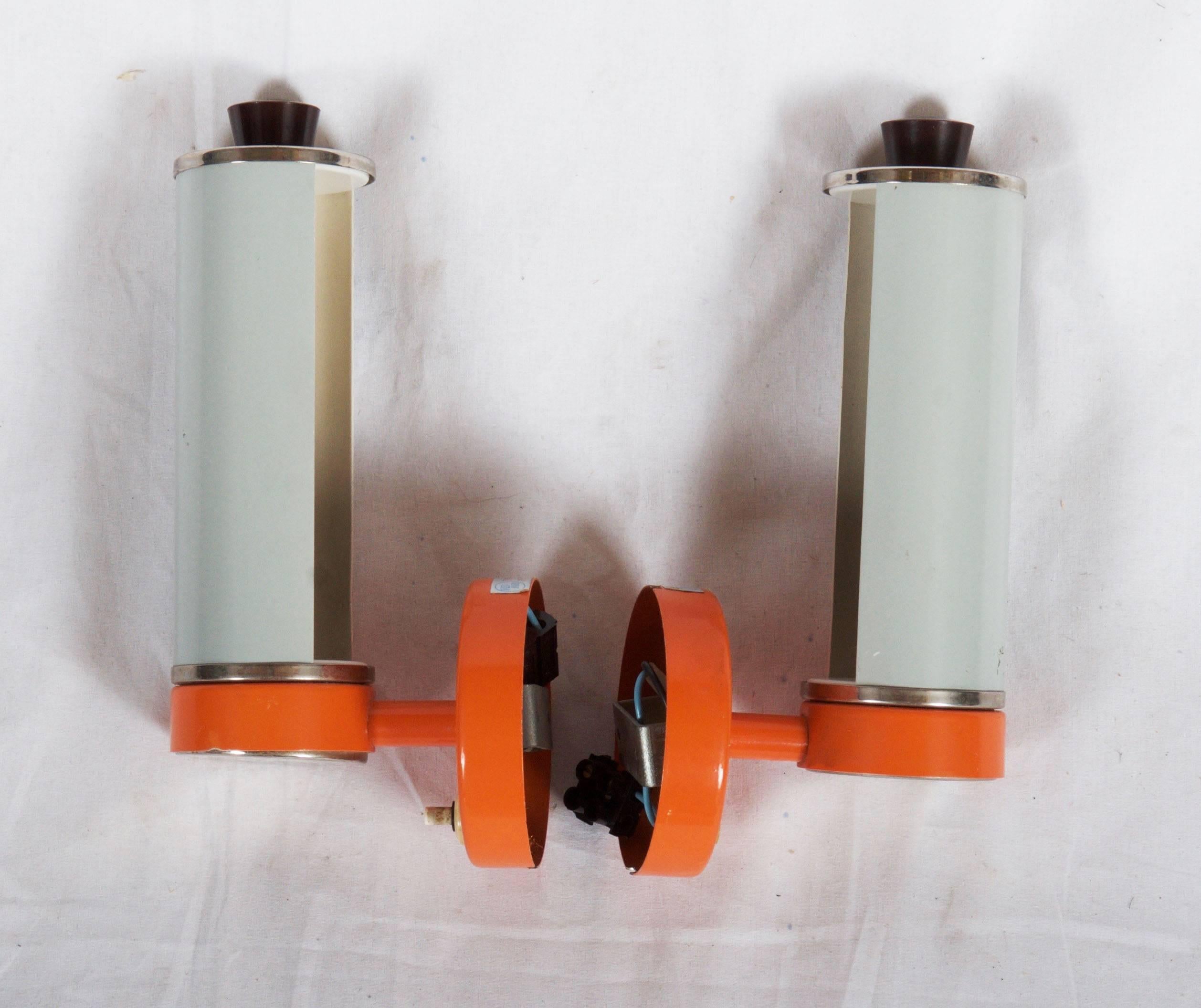 Steel orange/white painted sconces with one E14 socket and bakelite parts from the 1960s.