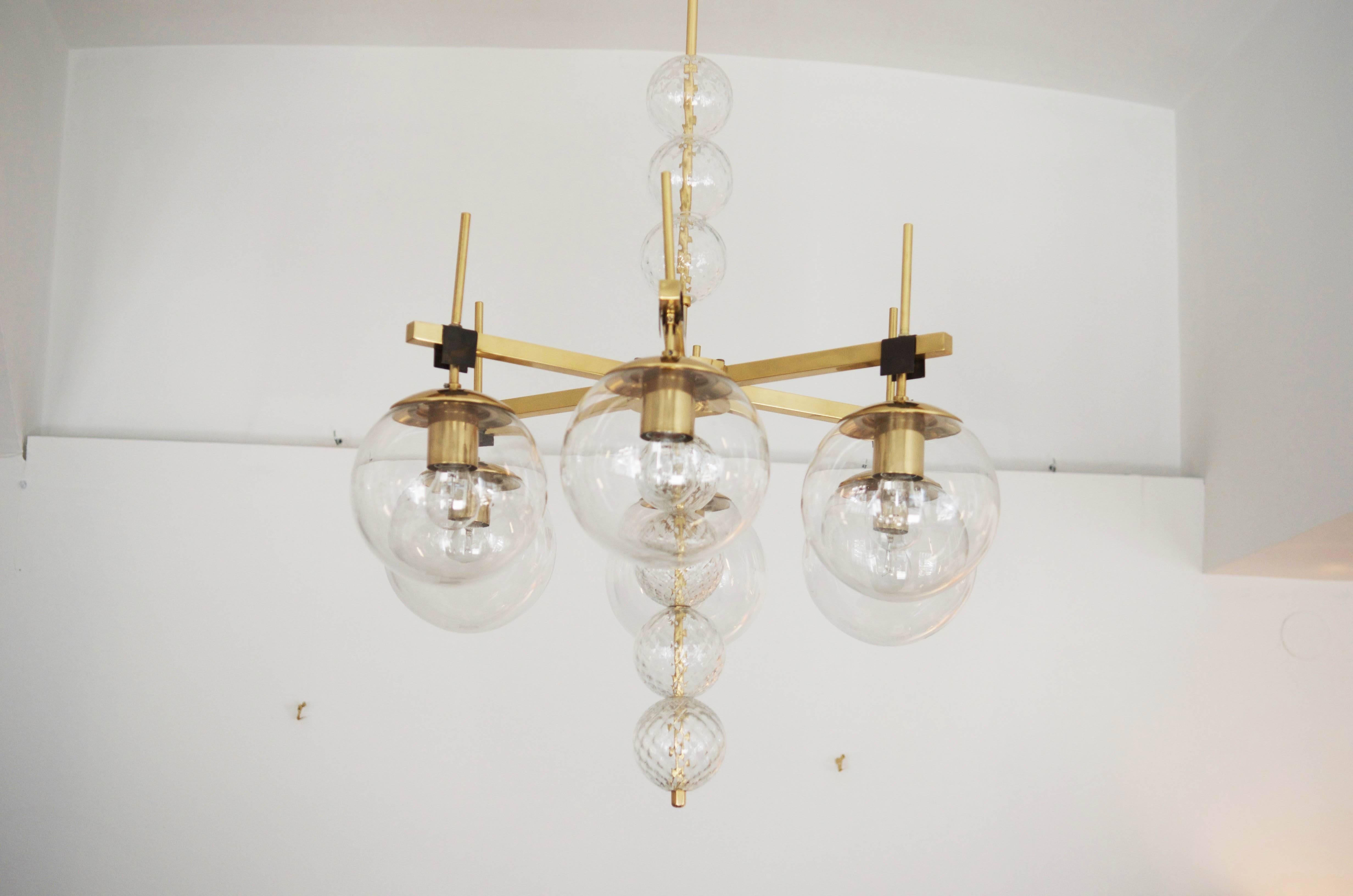 Large brass construction with clear crystal hand blow balls Europe, 1960s. 
The chandelier is beautifully restored with new electric.
The total length will be changed on request.
 