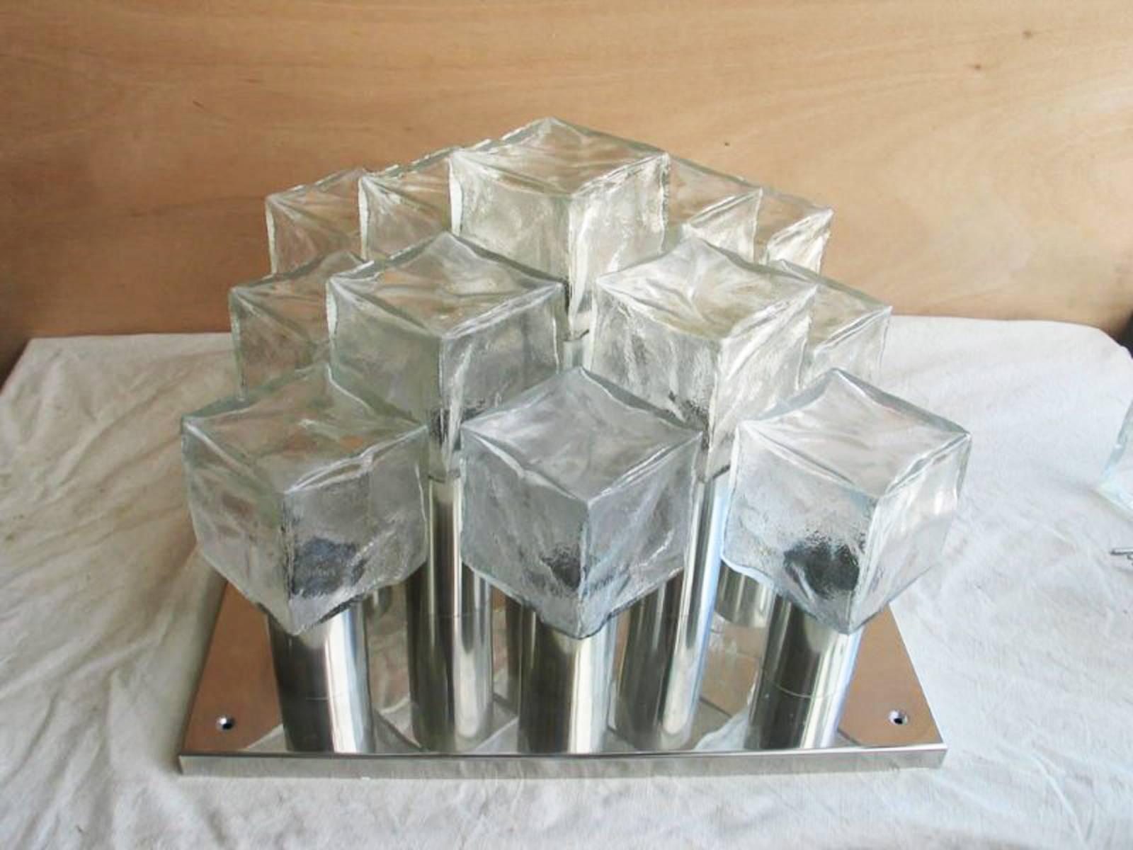 Stainless steel frame high gloss finish, flush mount with thirteen hand blow ice glass cubic formed elements, fitted with thirteen E14 sockets, made in Austria by J. T. Kalmar in the late 1960.
Perfect original condition.