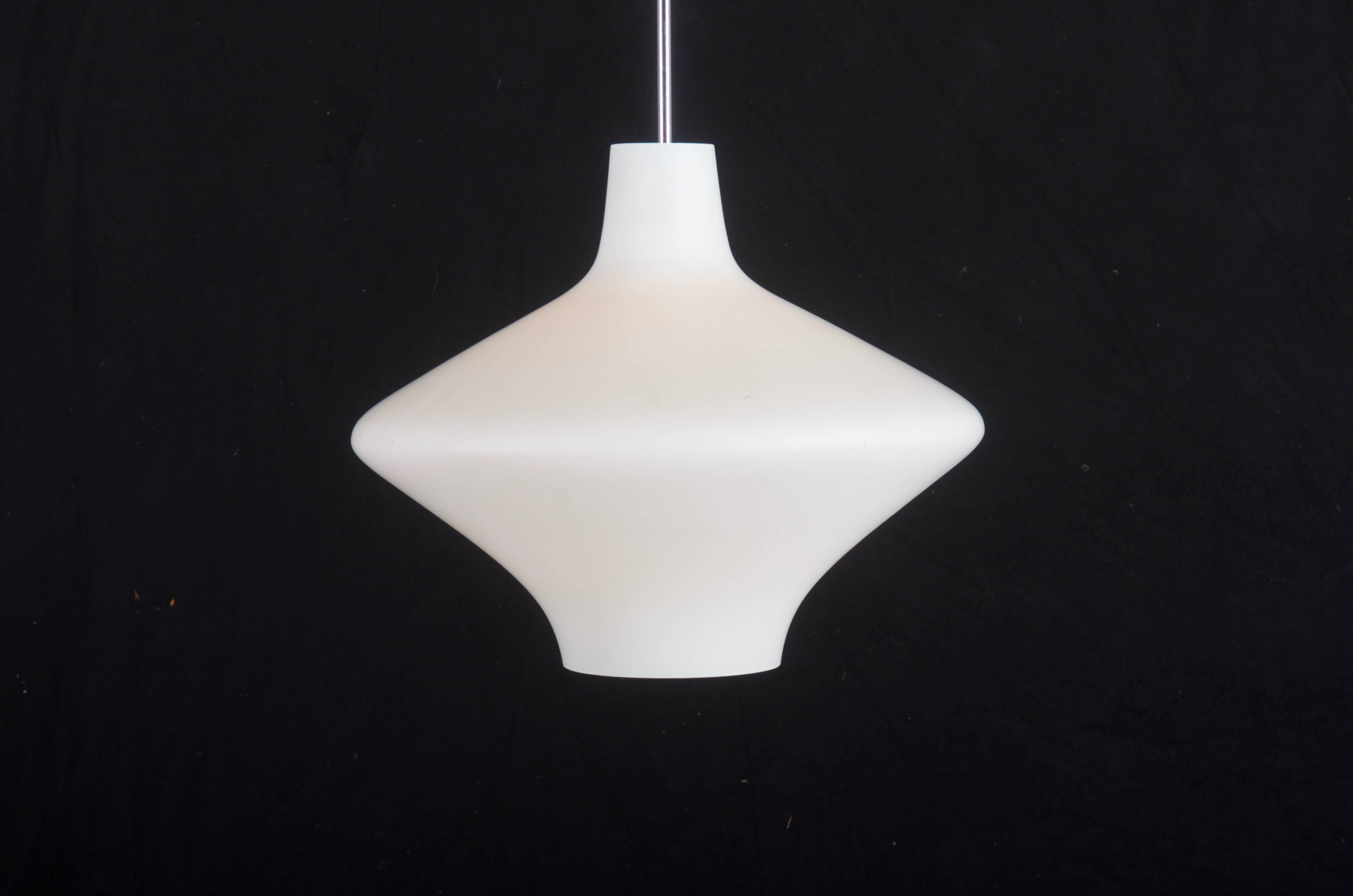 White opaline glass shade on steel chromed pendulum fitted with one E27 socket, from the 1960s.
Height of the glass only 37cm (14.56").
4 pieces available, more on request.