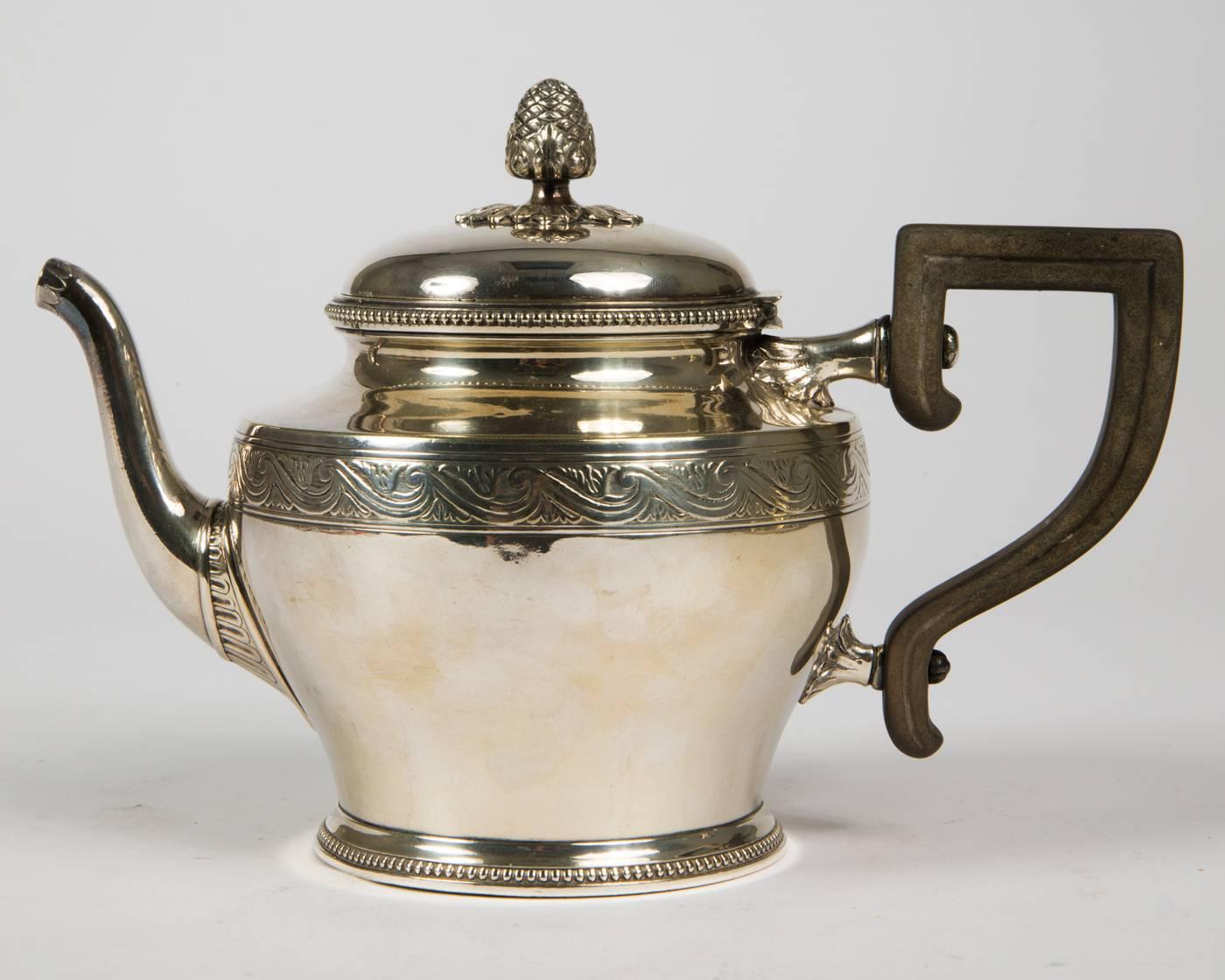 Set of five silver plated service, consisting of mocha and teapot with ebony handles, cream jug, sugar tray and tray, on the underside punctured company name, silver plated metal outside and gold-plated inside, total weight 2463 g, partial small