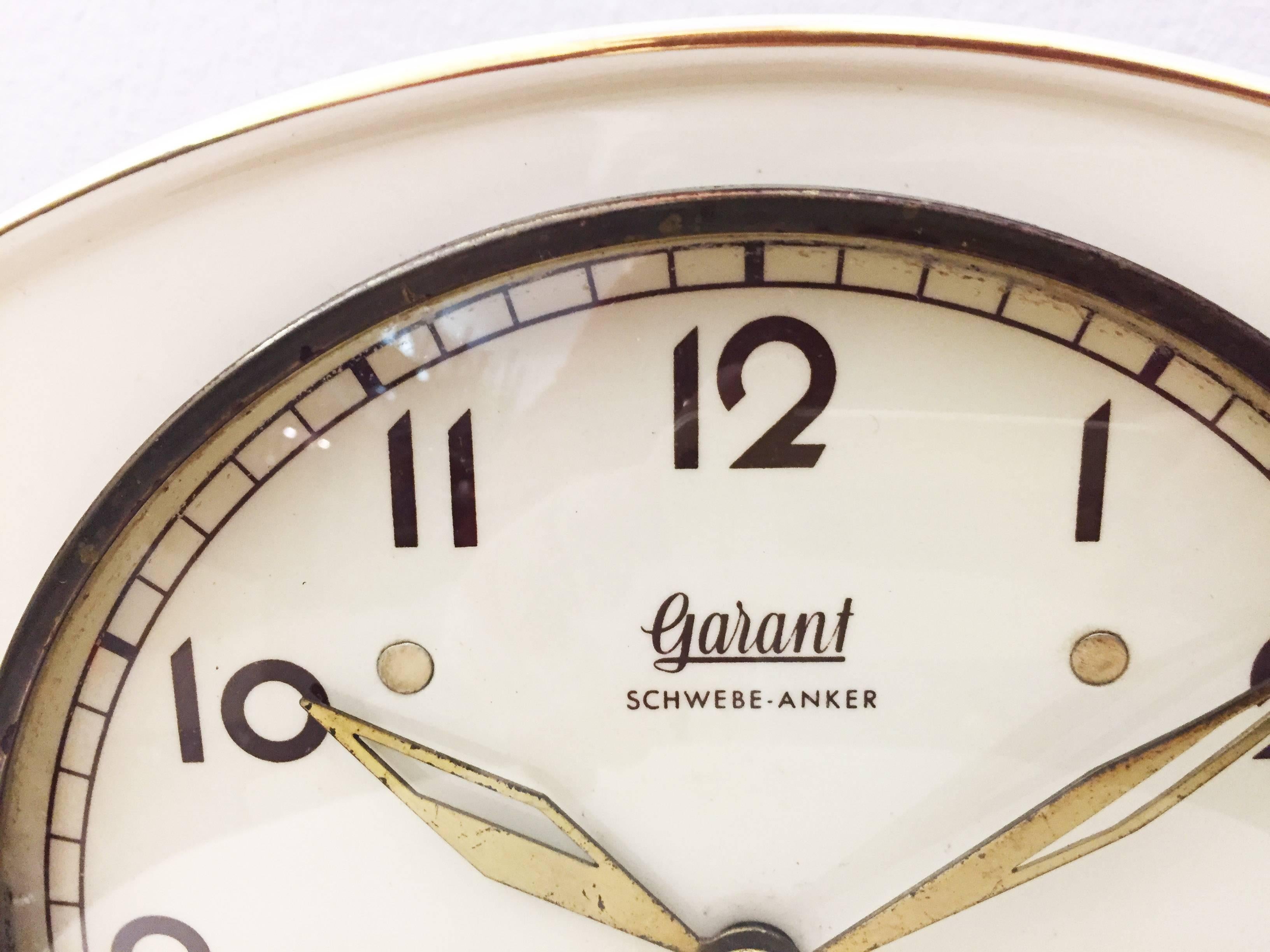 Ceramic clock with a mechanic movement with floating anchor made my Garant (later Hugo Hättich) in Germany in the early 1950s. 
Delivery time about 2-3 weeks.
The movement will be check by a clock maker before shippment. It can be also replaced