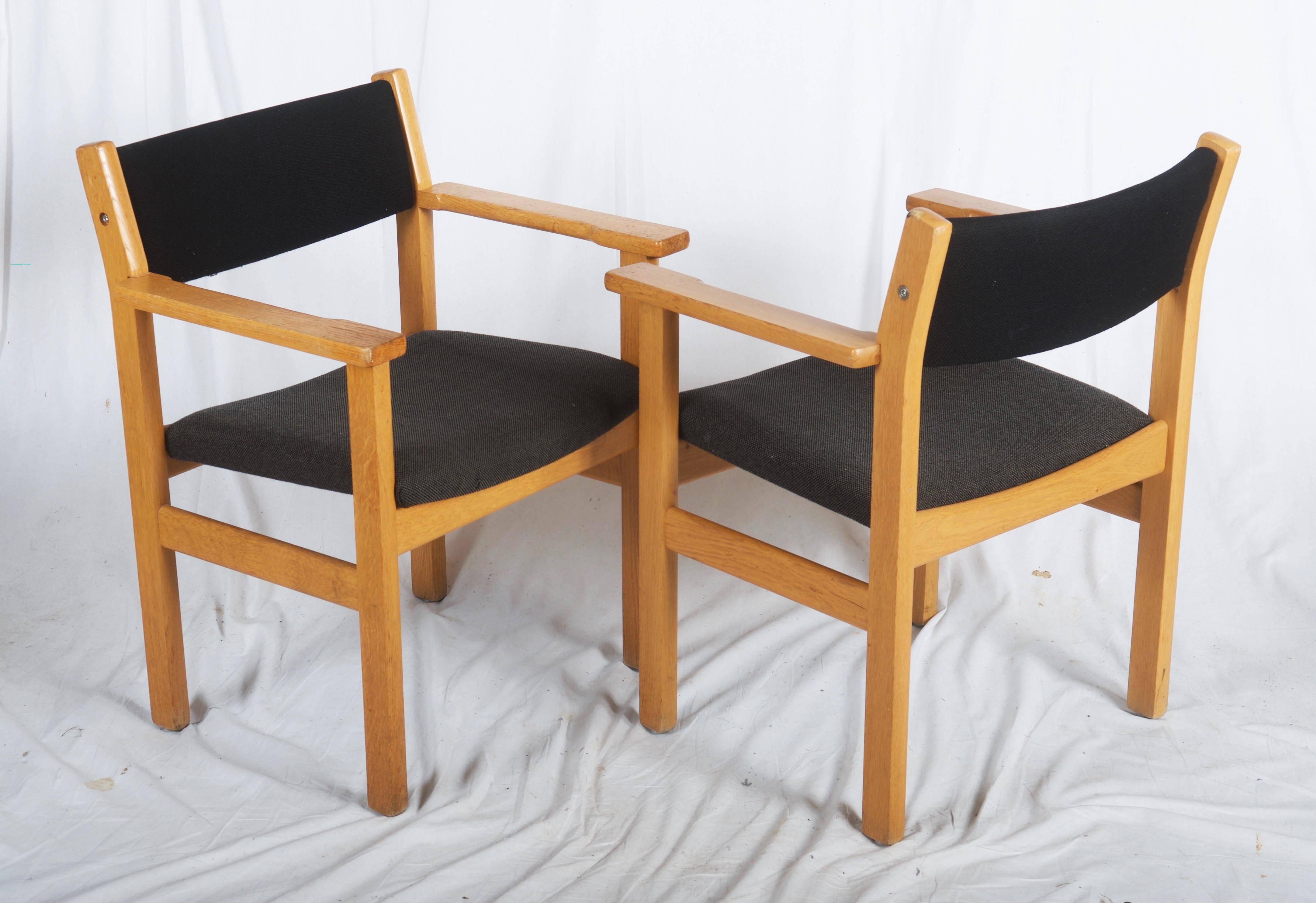 Danish armchairs designed by Hans Wegner for GETAMA, Denmark. 
Chairs are made of solid oak and covered with original fabric. 
Some slight scuffing and scratches based on normal wear but overall in good condition. Fabric is clean and in very good