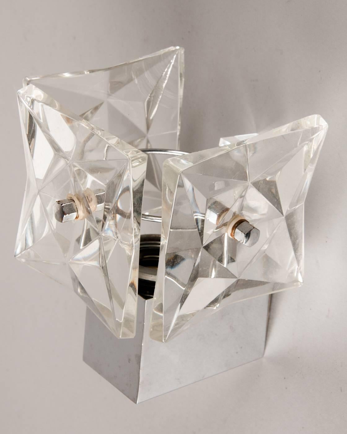 Small wall lights or prism lights of the 1960s by Kinkeldey Germany. Chrome-plated metal frame with mounted, faceted glass prisms. 
Dimensions: Each width13 cm approximately, depth approximately 15 cm, height approximately 18cm. 
Original used