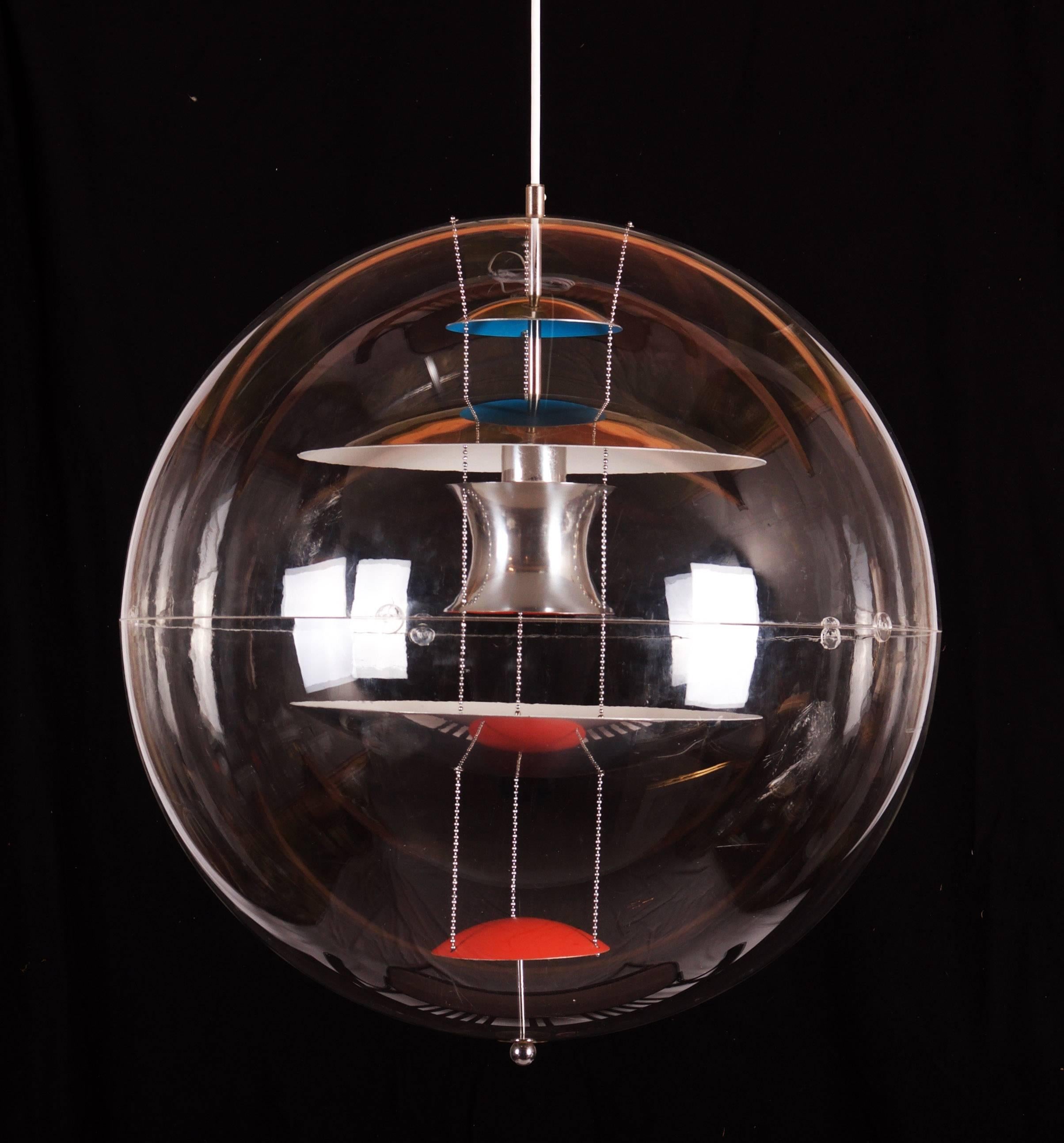 The biggest one ever produced, the iconic design by Verner Panton for Louis Poulsen in 1969. This acrylic globe encompasses five curved reflectors suspended through the center - three chrome, one red, the other blue. 
In perfect original vintage
