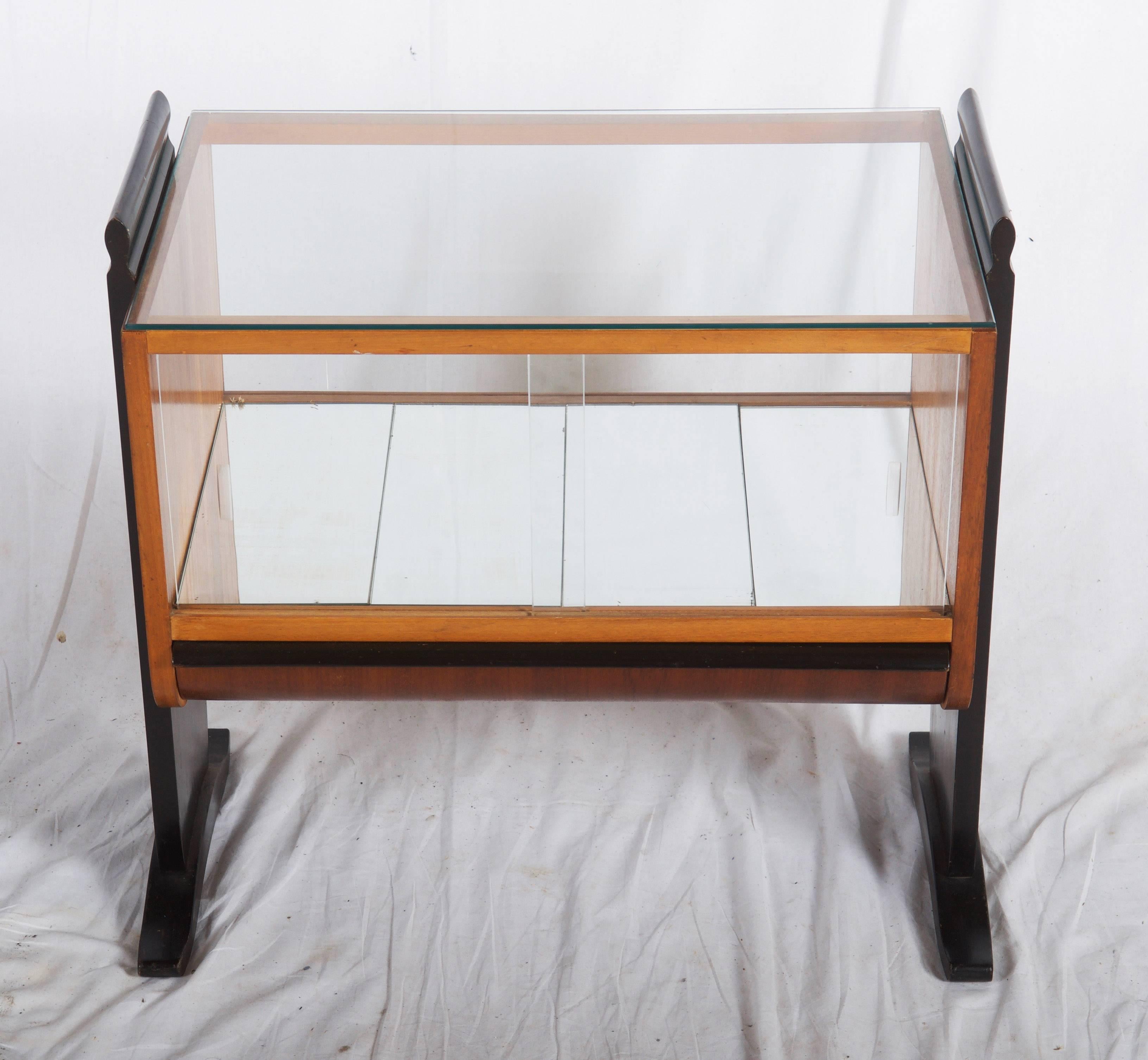 Beech with walnut veneer, side parts/legs black lacquered. Glass top and sides, mirror bottom. Original excellent condition. Designed in the 1930s by Jindrich Halabala for Spojene UP-Zavody, Czechoslovakia. On request two additional