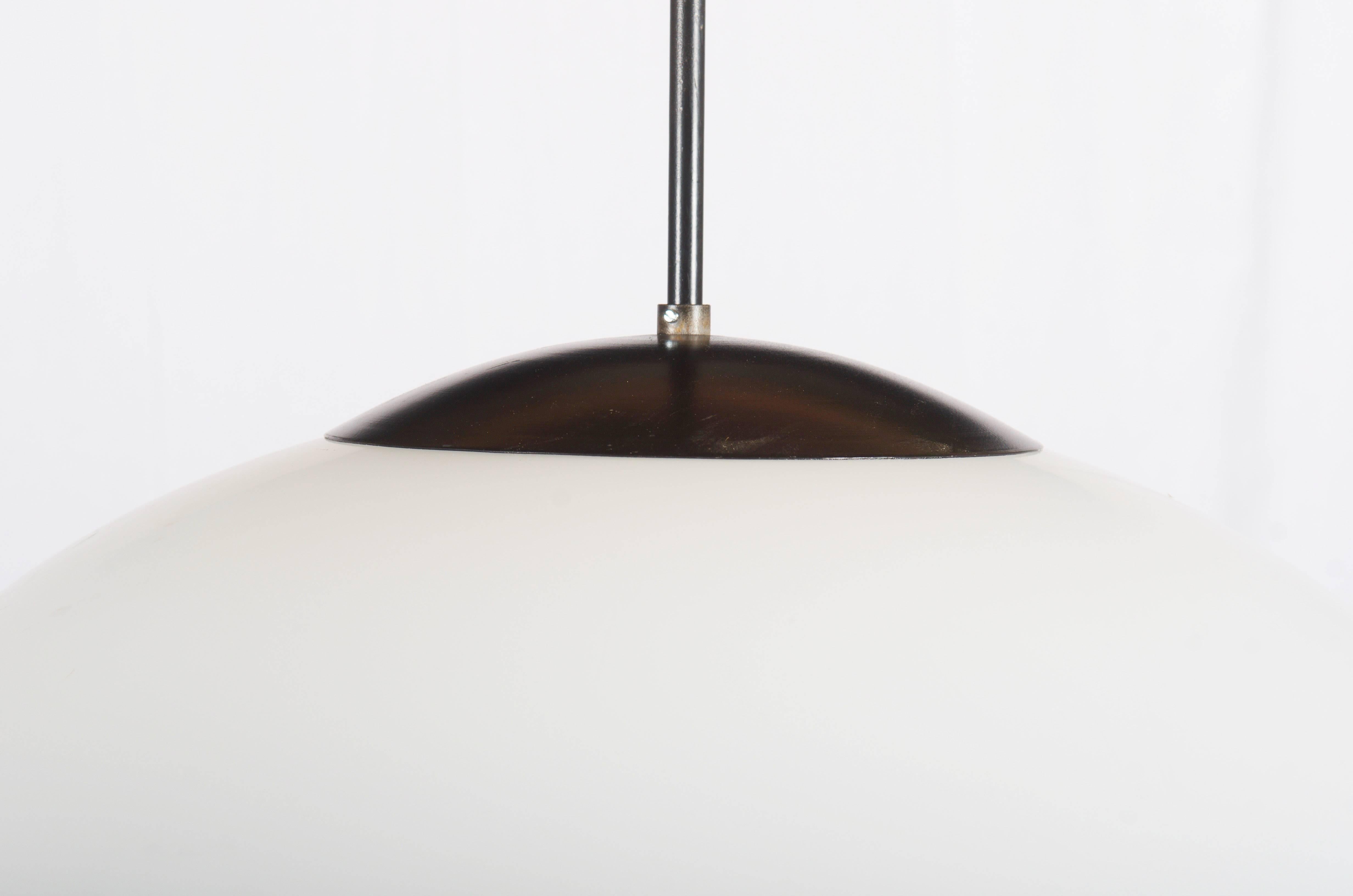 Steel hardware black pained with opaline glass shade in ellipsoid form.
From the 1970s.