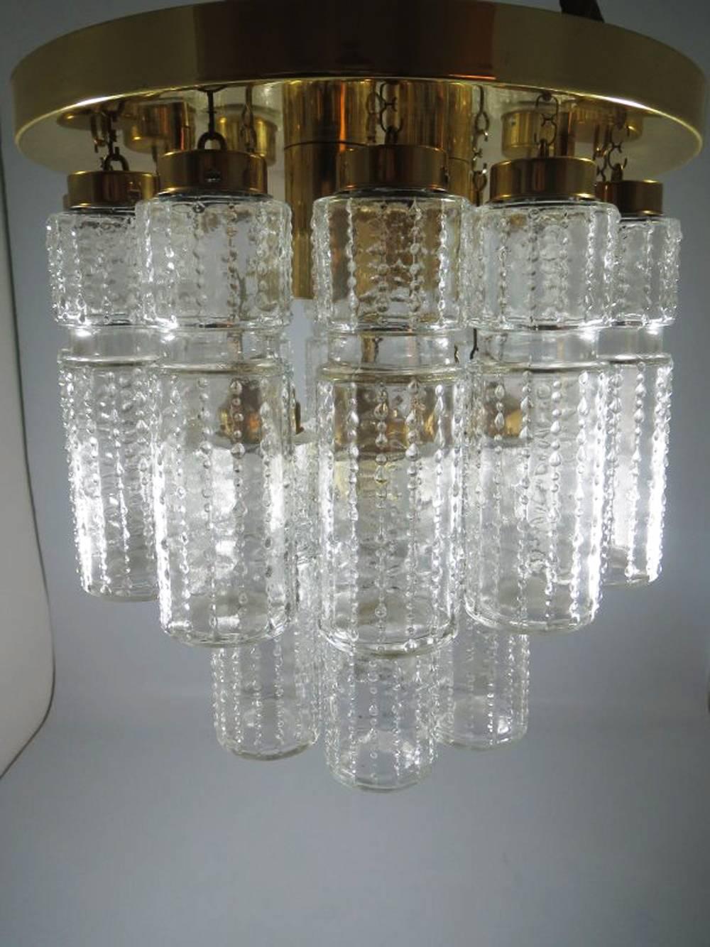 Amazing flush mount chandelier with 18 hanging hand blow textured hollow glass prisms mounted on a brass frame. Made by Glashütte Limburg in Germany model number 3170 and designed by Boris Tabacoff in the 1970s.
Excellent original condition. Fitted