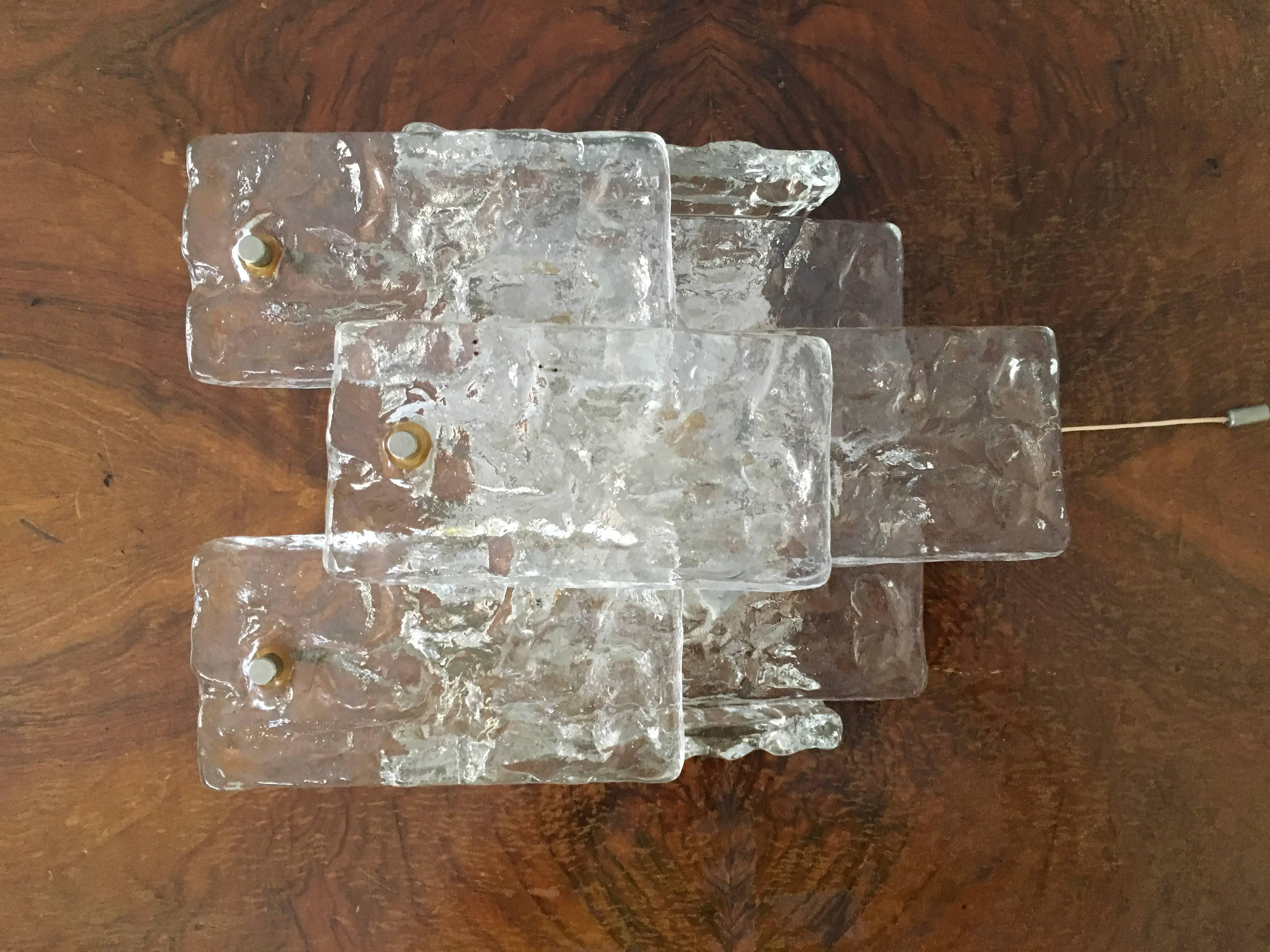 Ice crystal glass wall sconce. Metal hanger plate.
By J. T. Kalmar, from the 1960s.