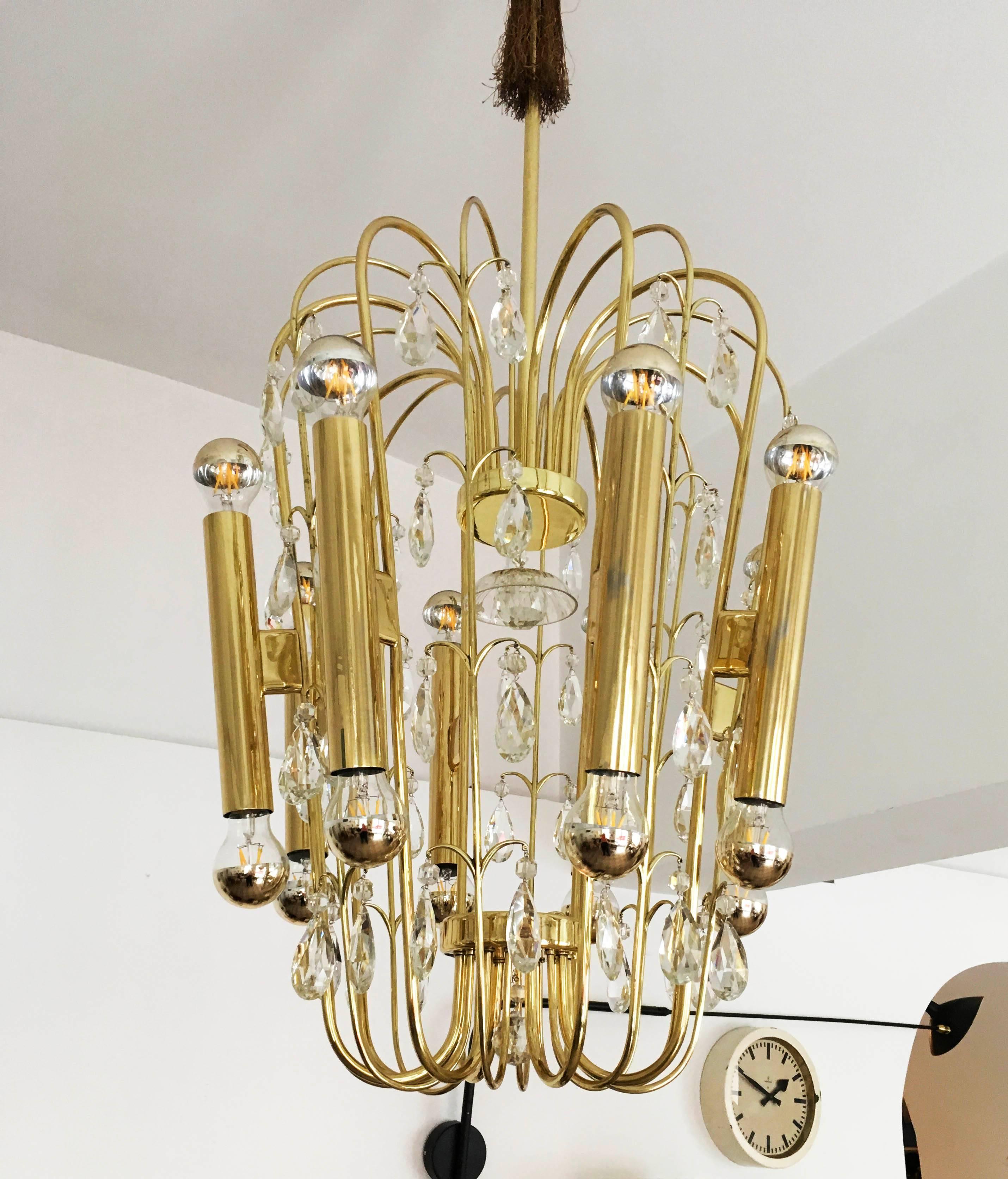 Brass construction with cut crystal prism, fitted with 16 E27 sockets. Made in Austria in the early 1950s. Chandelier is fully restored with new electric.