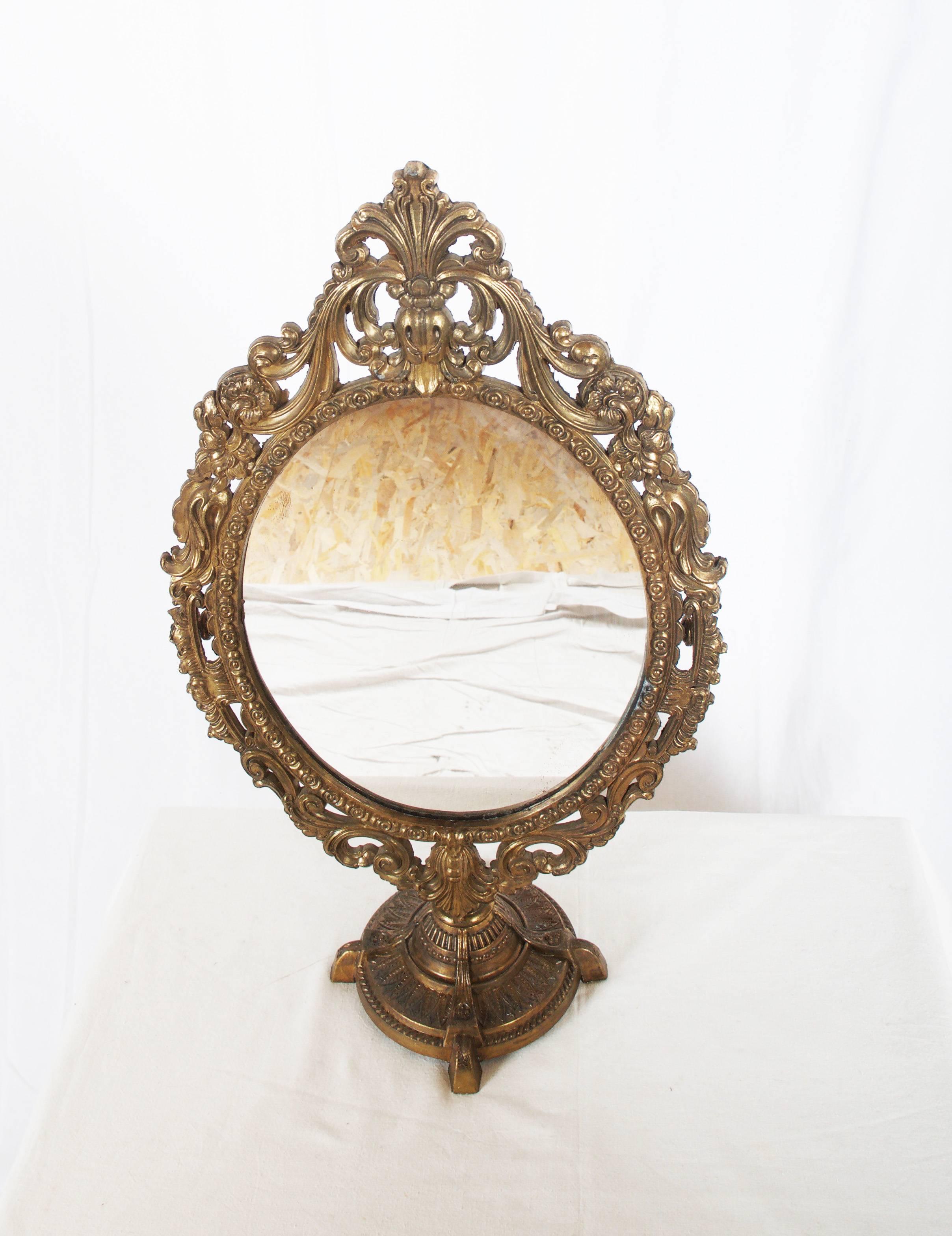 Brass round food and oval frame with mirror. Made in the 1860-1880 in Baroque style.