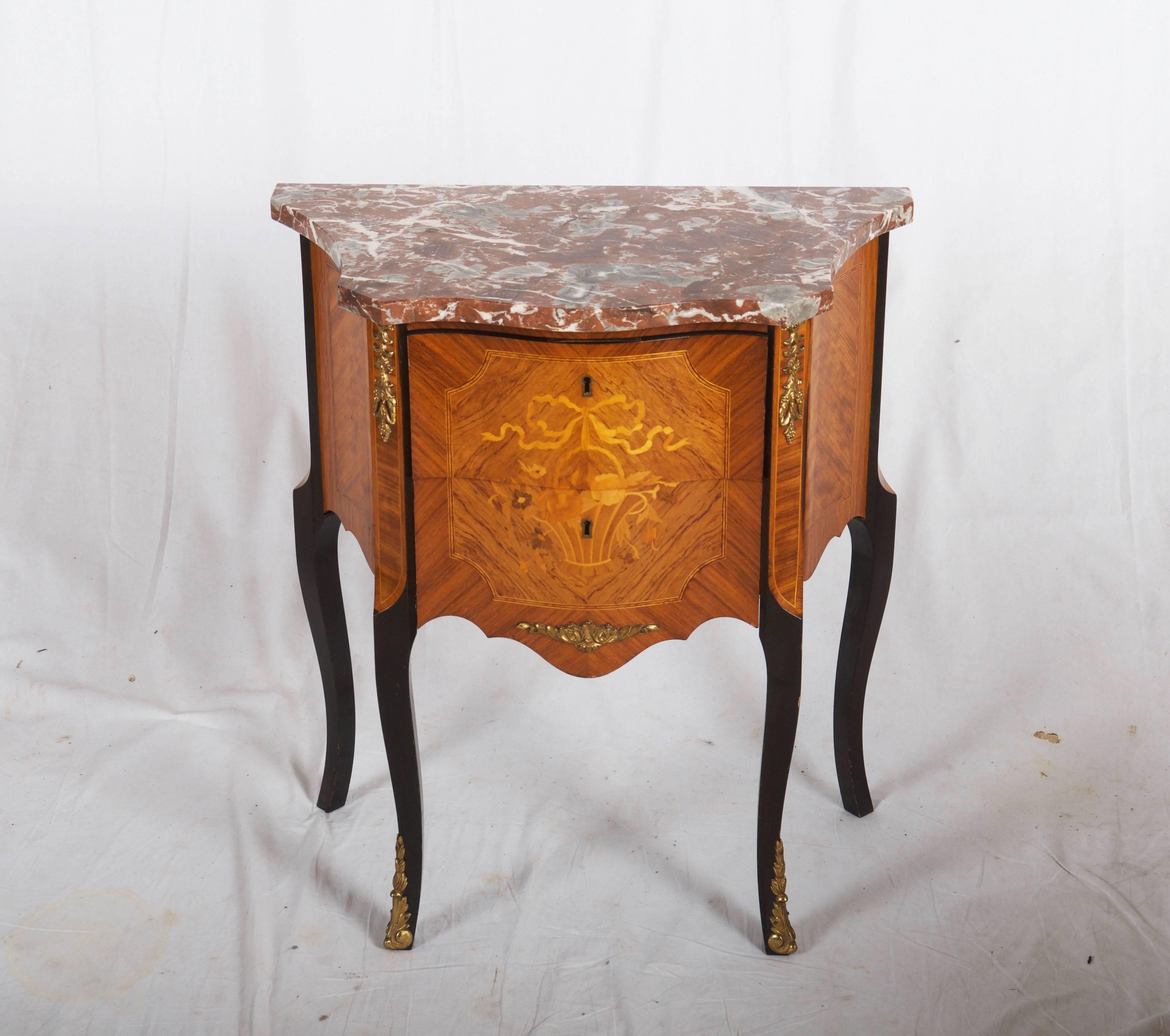 Louis XV style side table with floral basket marquetry, figural gilt bronze details. There are two drawers with key. Made in the 1950s in France.