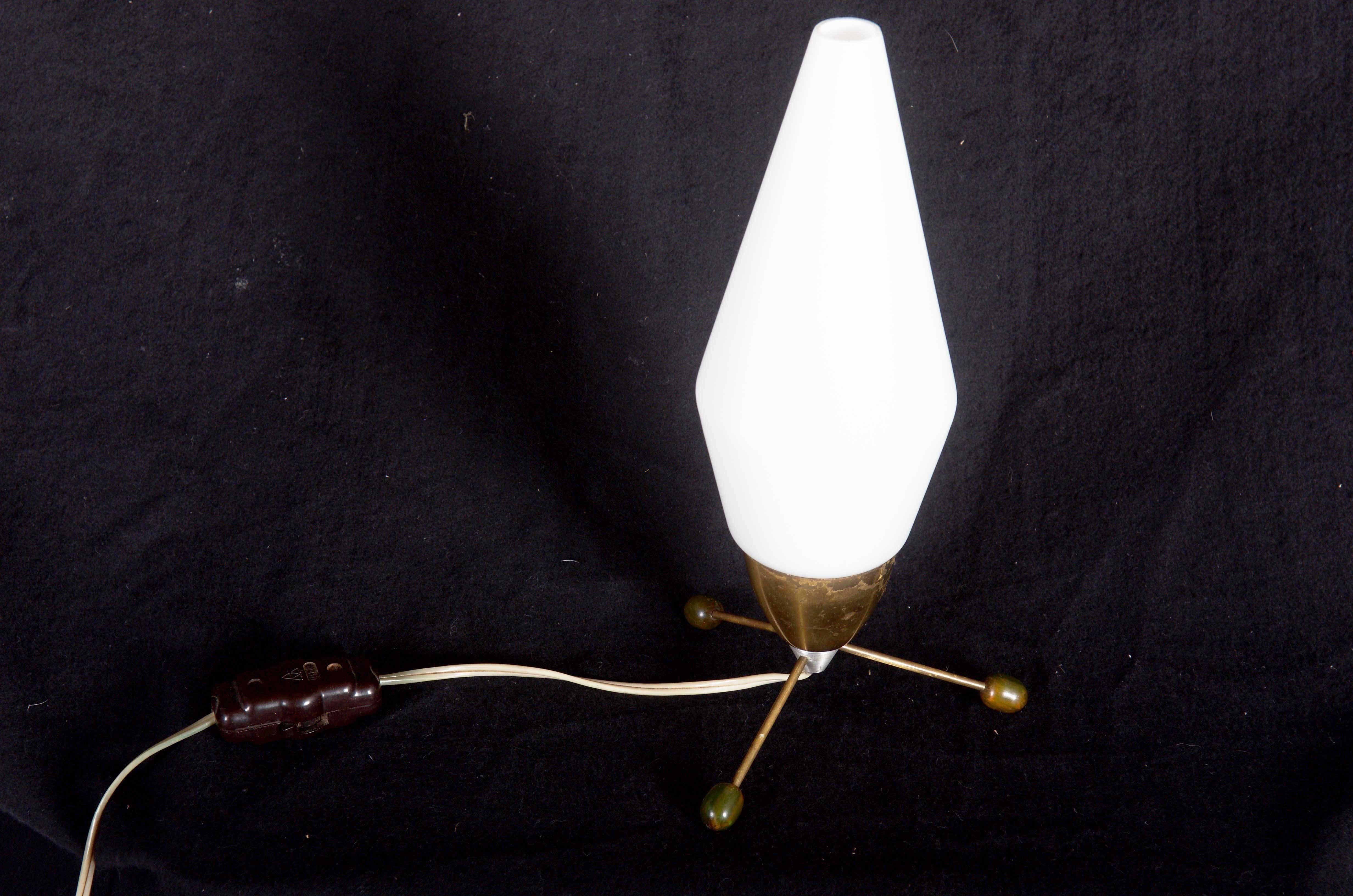 Brass base on three legs with wooden balls on the ends and with opaline glass shade, fitted with one E14 socket. 
Designed by Stanislav Kucera in the 1960s for 