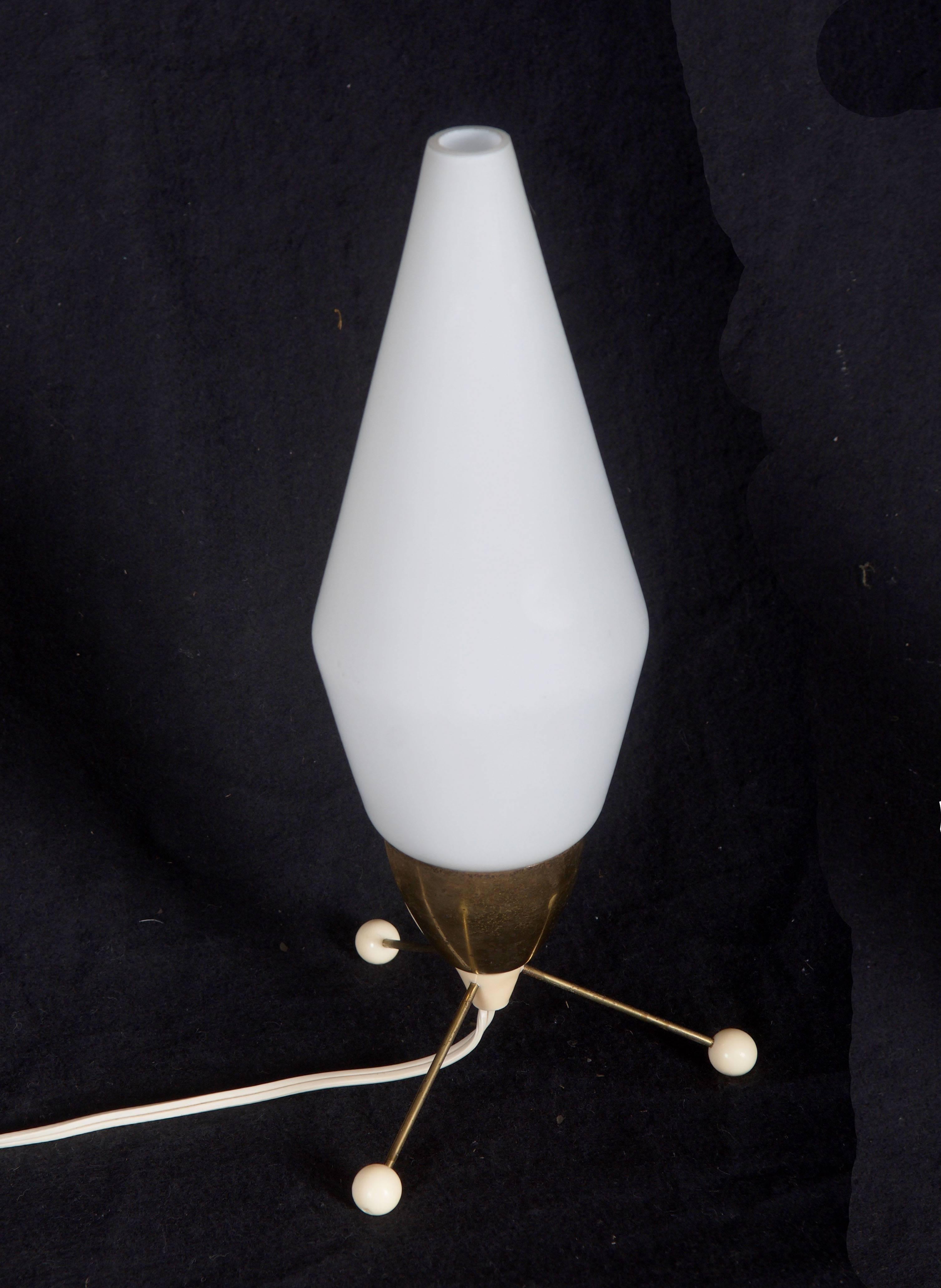 Brass base on three legs with plastic balls on the ends and with opaline glass shade, fitted with one E14 socket. 
Designed by Stanislav Kucera in the 1960s for 