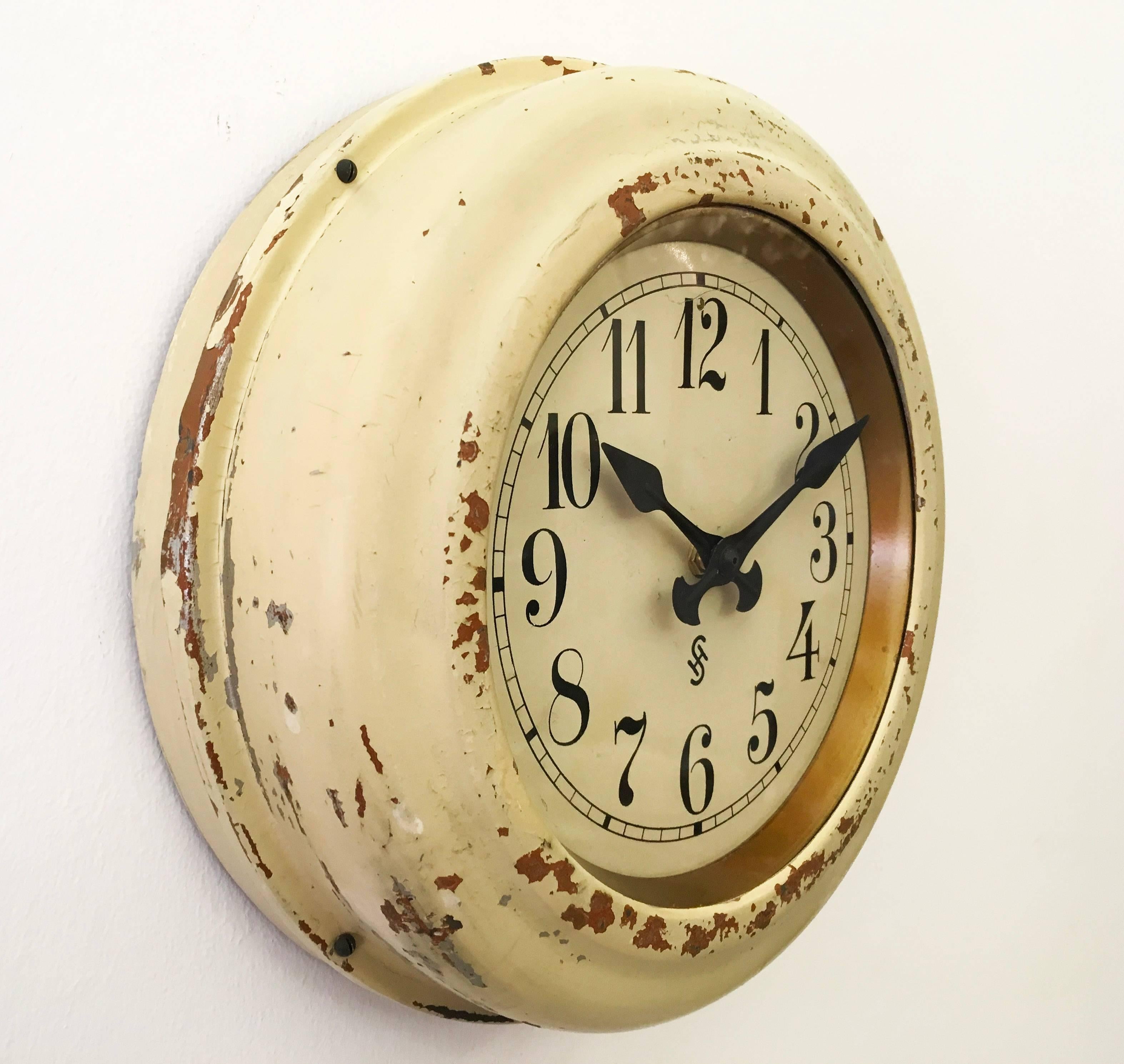 Steel painted with glass front made by Siemens Halske in Germany in the 1930s.
Formerly a station or factory slave clock, it is now fitted with a modern quartz movement with a battery.
 