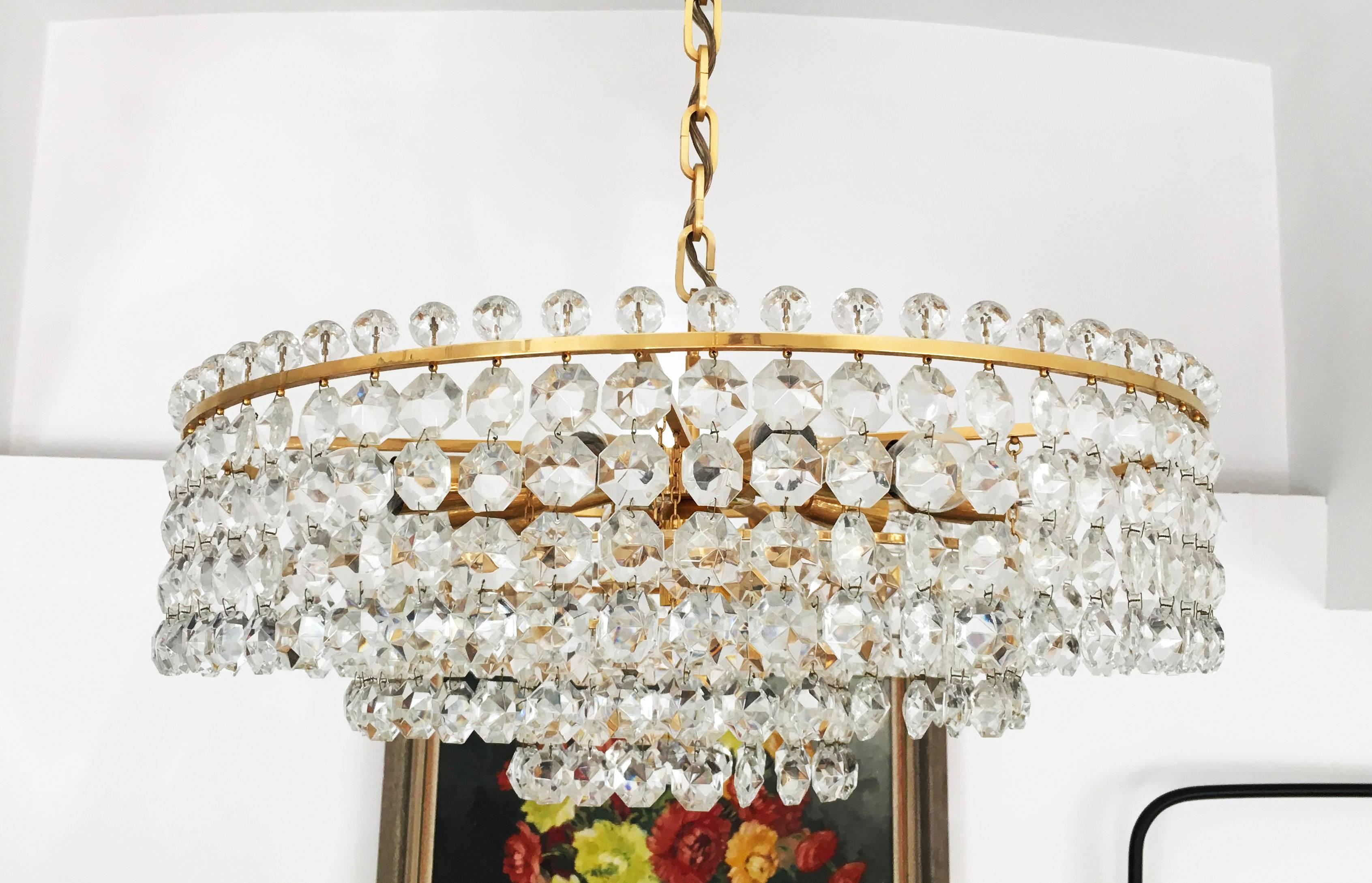 Three layers brass construction with cut crystal elements (octagons and pearls) fitted with eleven E14 sockets up to 60 watts each.
Made in Vienna in the 1960s by Bakalowits & Sohne.
Dimension of the chandelier only is: diameter 60 cm (23.62