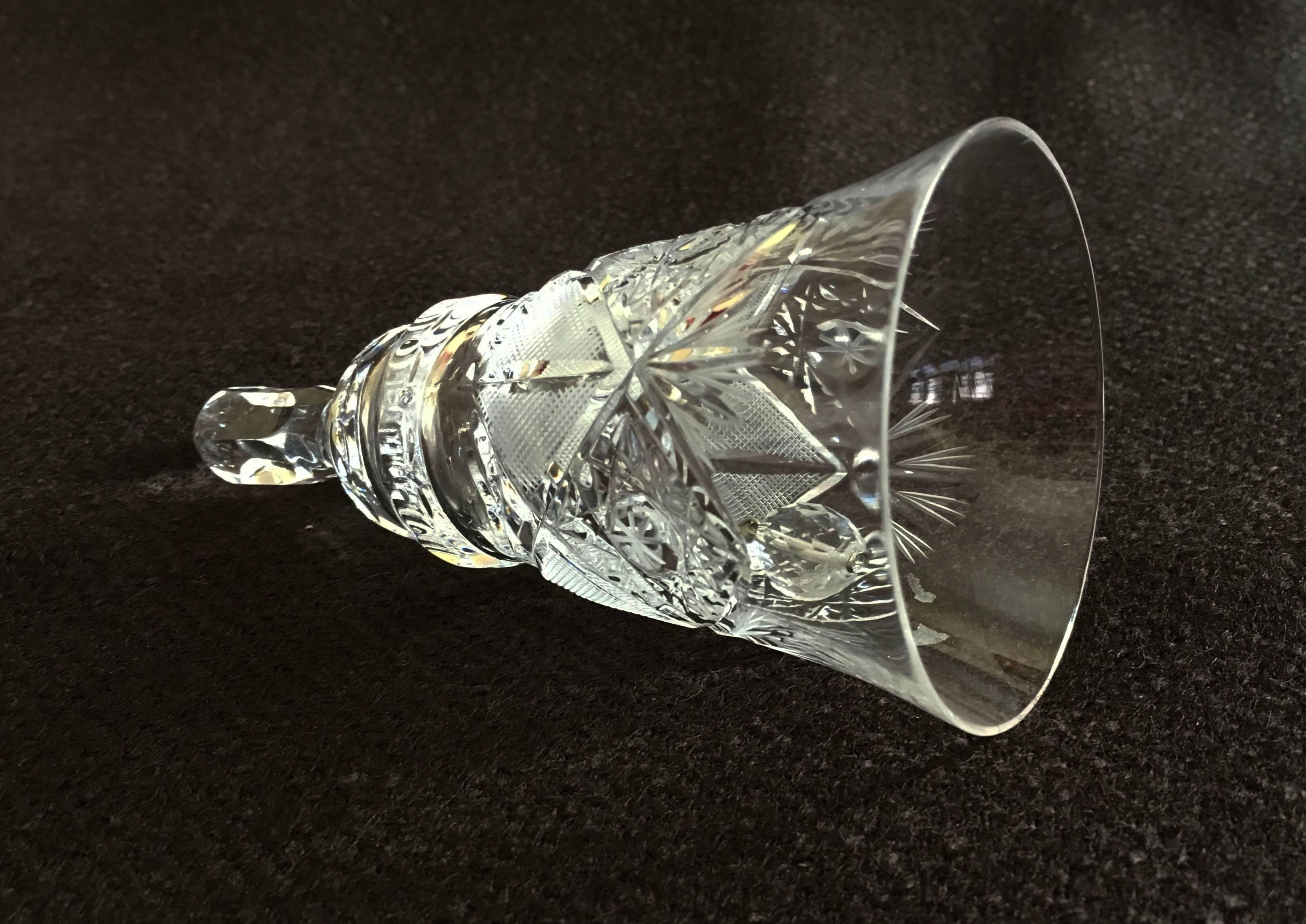 Extravagant cut and polished crystal table bell made, circa 1970s in one of the Bohemian glass works. The cutting is especially fine and deep with the very intricate patterns.