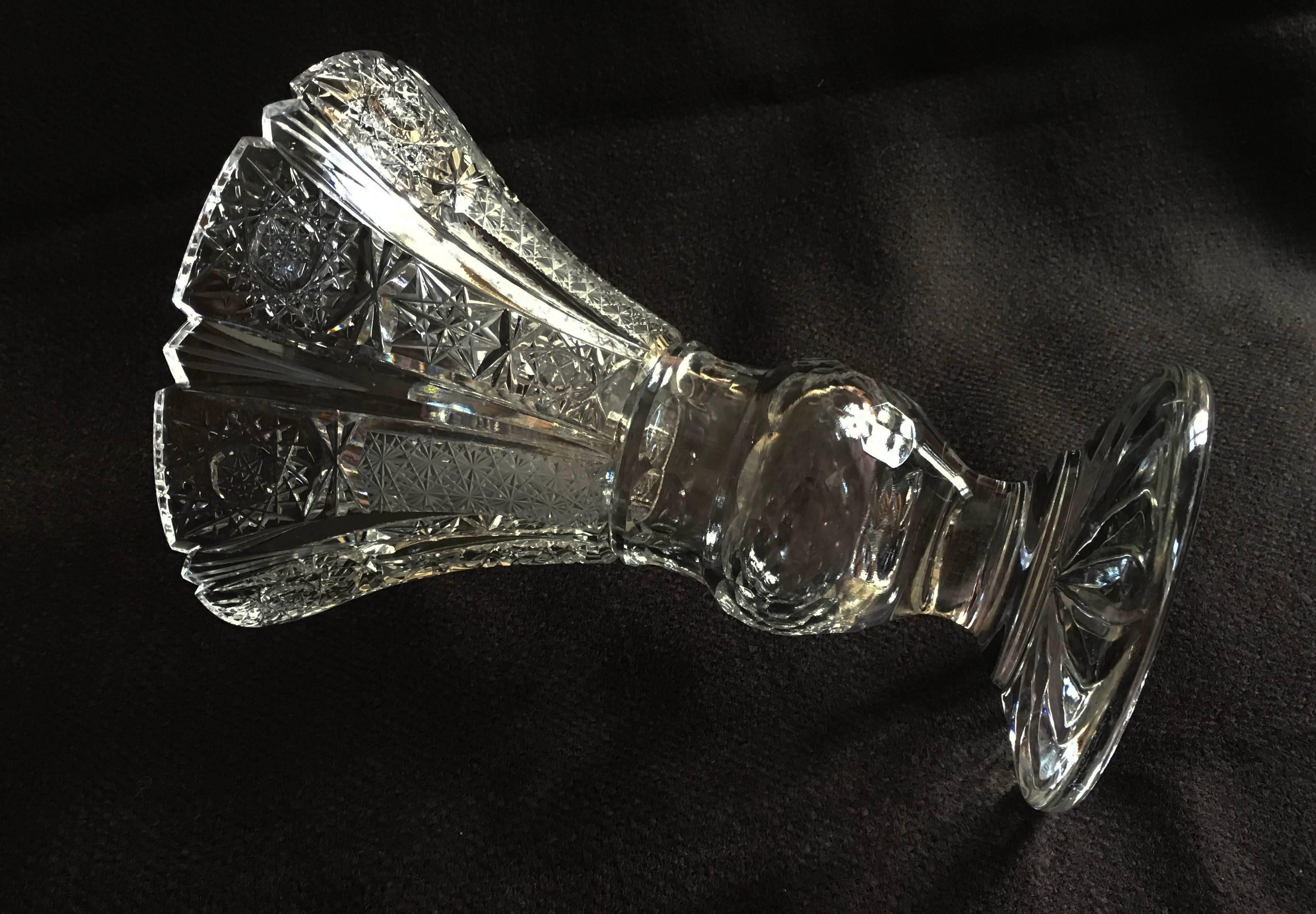 Extravagant cut and polished crystal flower vase made circa the 1970s in one of the Bohemian glass works. The cutting is especially fine and deep with the very intricate patterns.