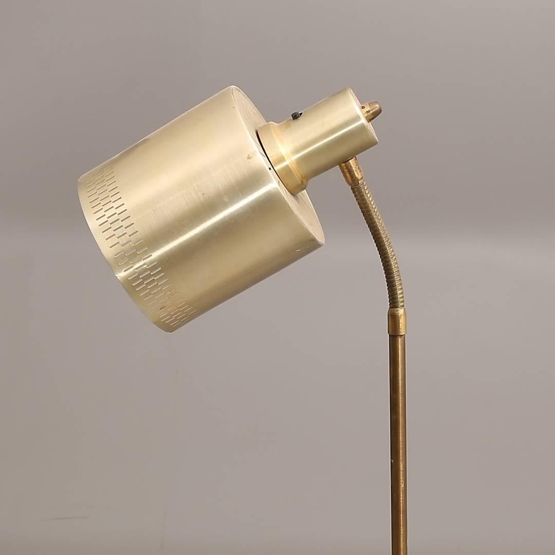Brass construction with aluminium shade fitted with one E27 socket. Made in Denmark in the 1970s.