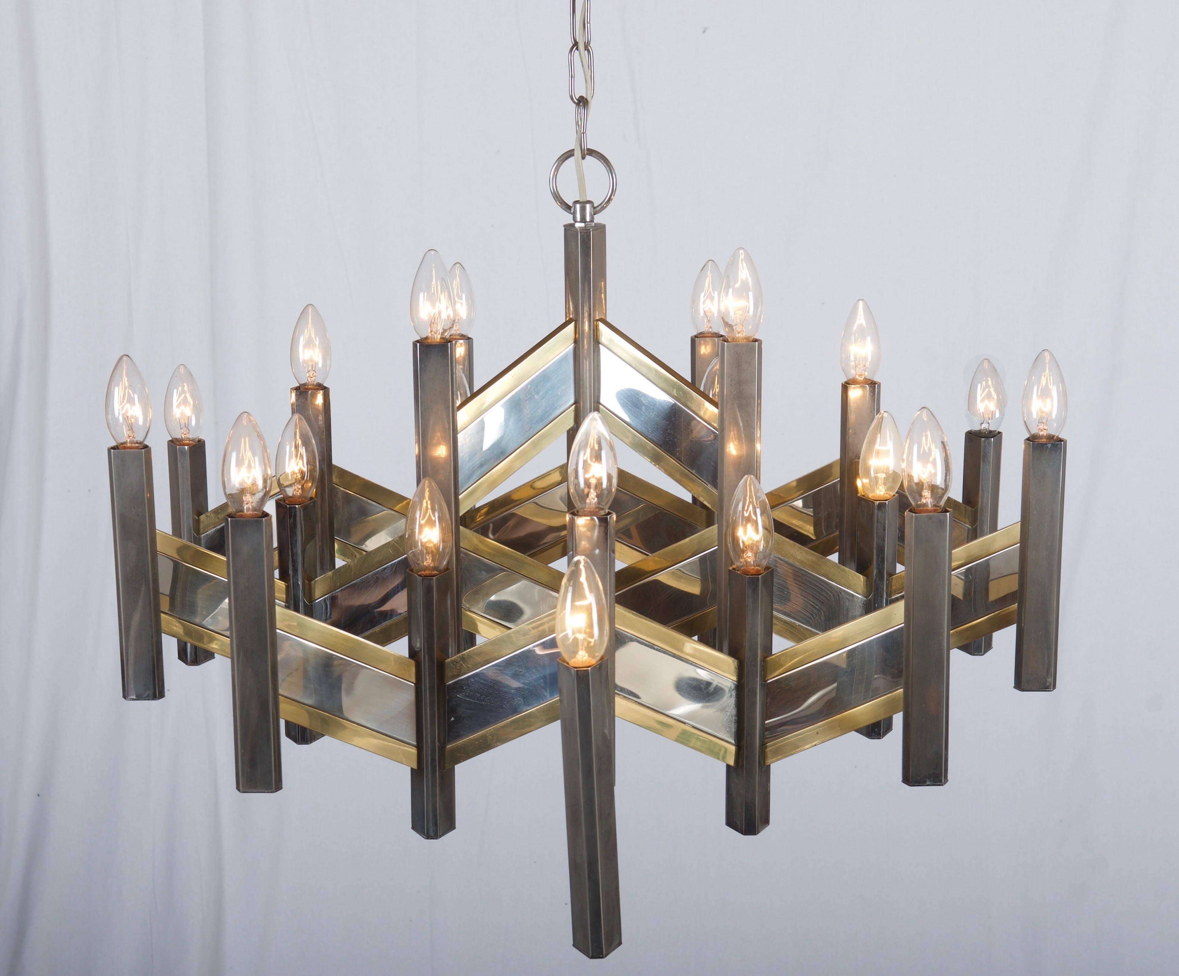 Rare huge chevron zig zag body form chandelier fitted with 21 E14 lights up to 60watts designed by Gaetano Sciolari in the 1960s. Made of polished chrome and brass. Some scratches and patina to chrome panels, the reason for the price.