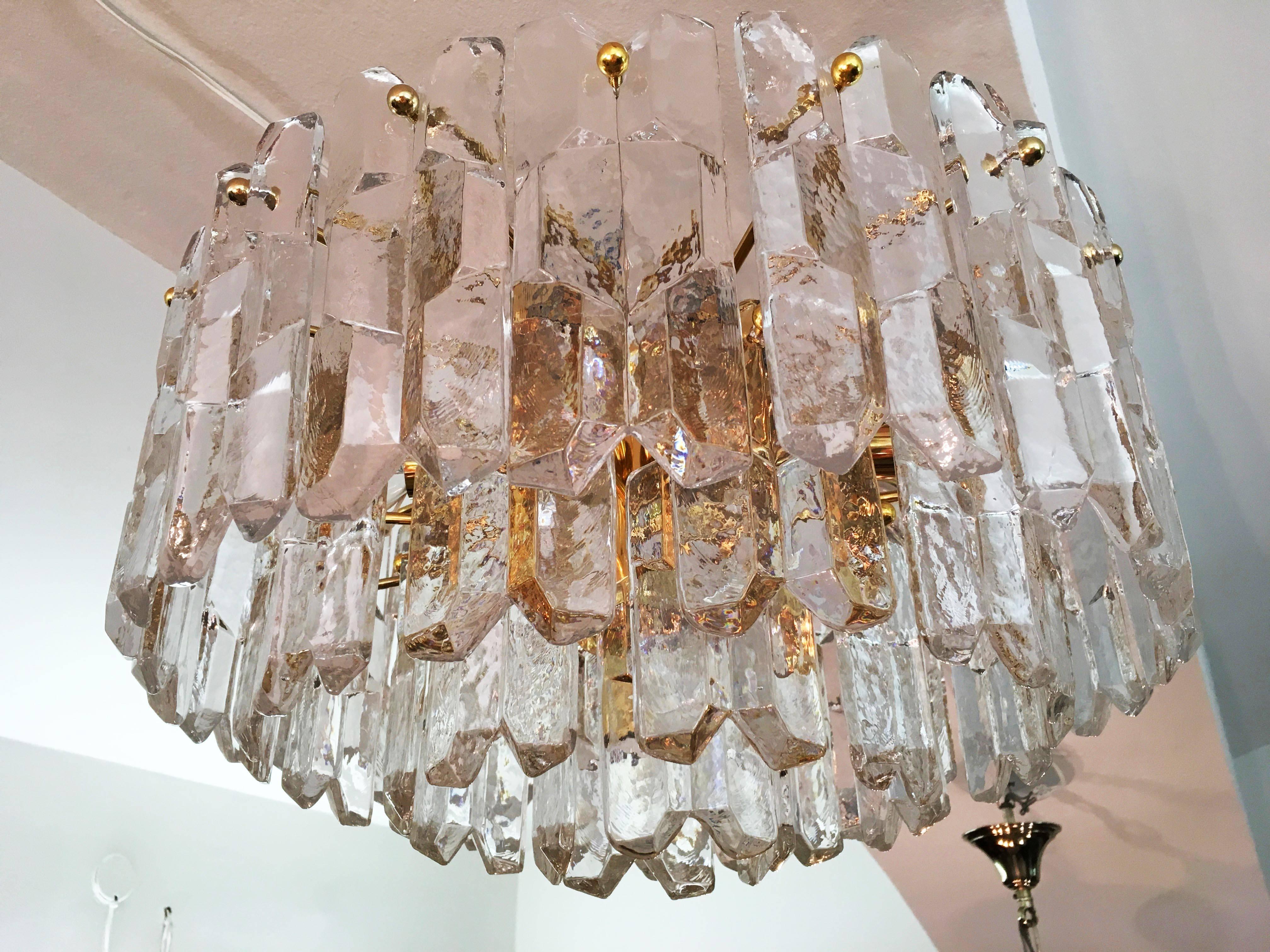 Breathtakingly beautiful chandelier by J. T. Kalmar Austria from the 1970s. Brass frame gold-plated with 42 heavy crystal glasses in four layers, fitted with 12 E14.
The chandelier is in excellent original condition.
 