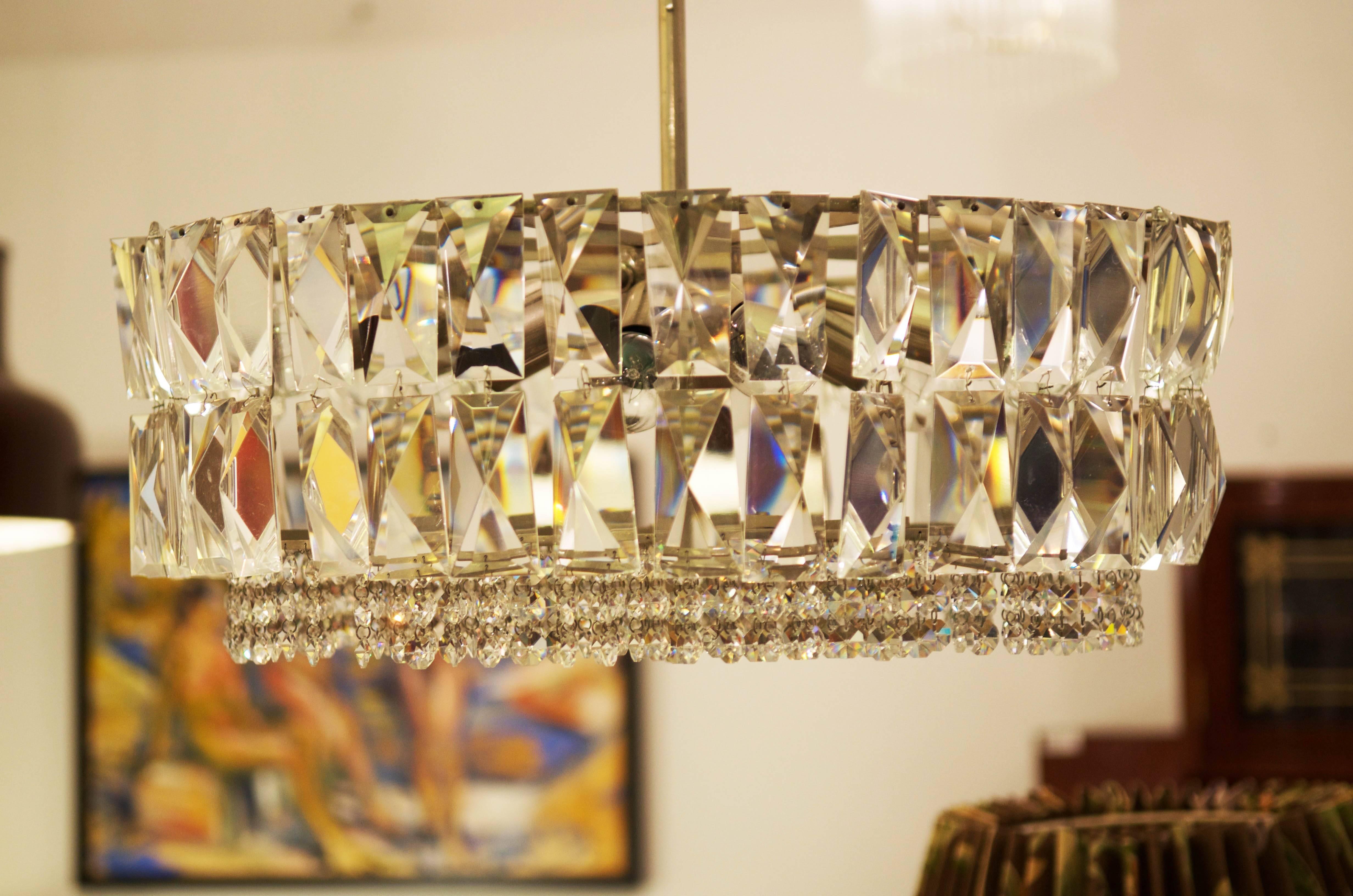 Impressive and stunning crystal chandelier from circa 1960s by Bakalowits & Sohne.
Brass construction nickel-plated with four ring with hand-cut crystals in the rombform.
(the pictues shows the chandelier before restoration with missing