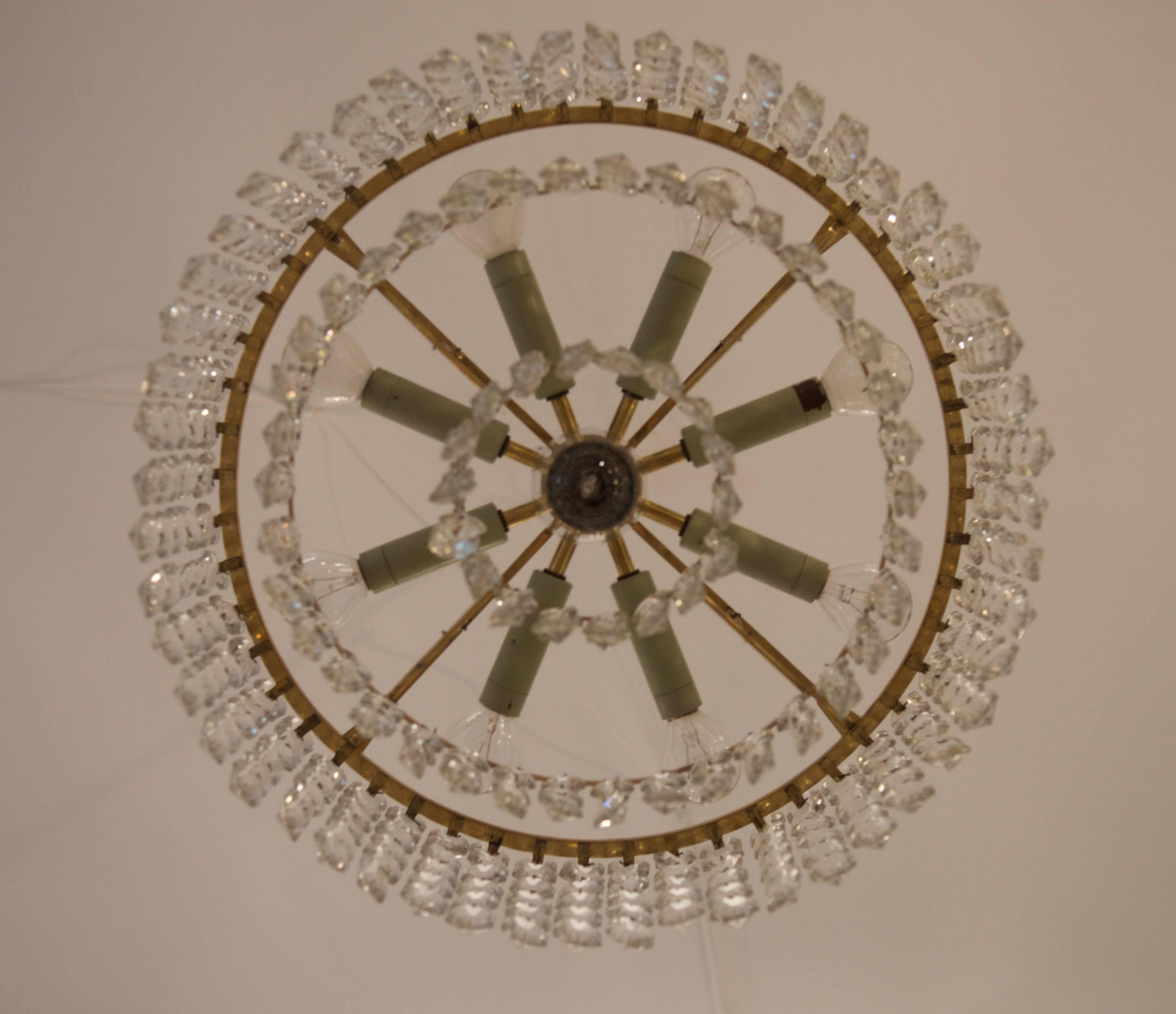 Brass construction with three rings with crystals and nine lights.
Vienna form the 1950's, signatur on the frame.
Dimention of the chandelier only is: diameter 44cm (17.32in) x 20cm (7.87in) height.
