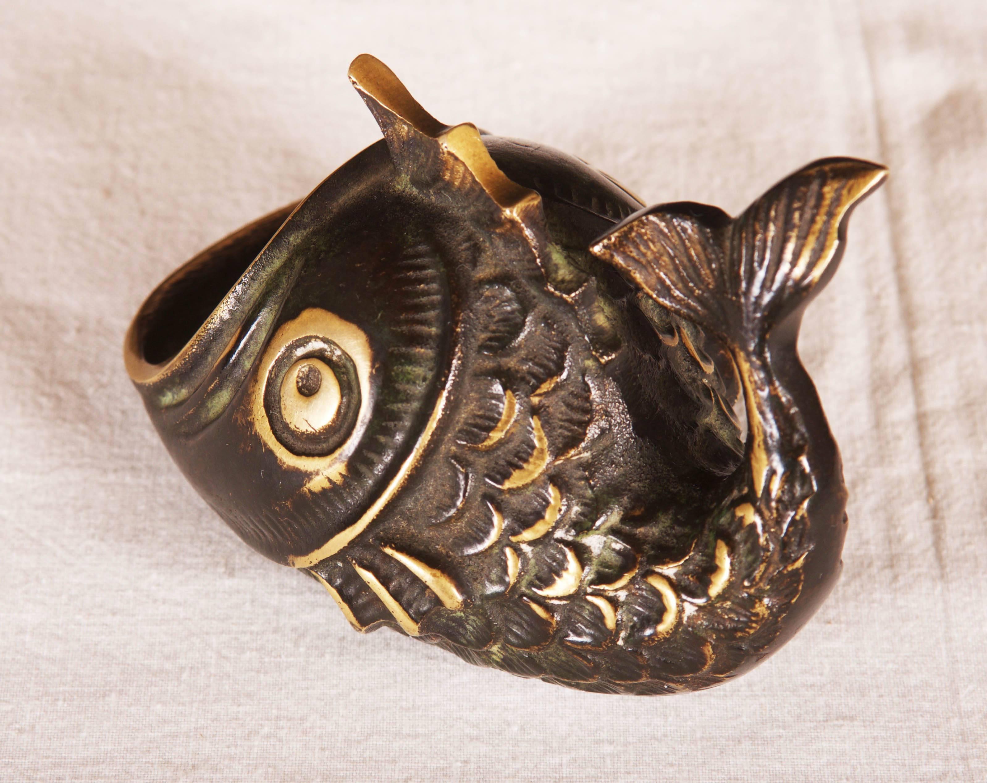 By Walter Bosse designed for Hagenauer in the 1950s.
It has a form of a fish and were made of blackened brass. 
Excellent original condition.