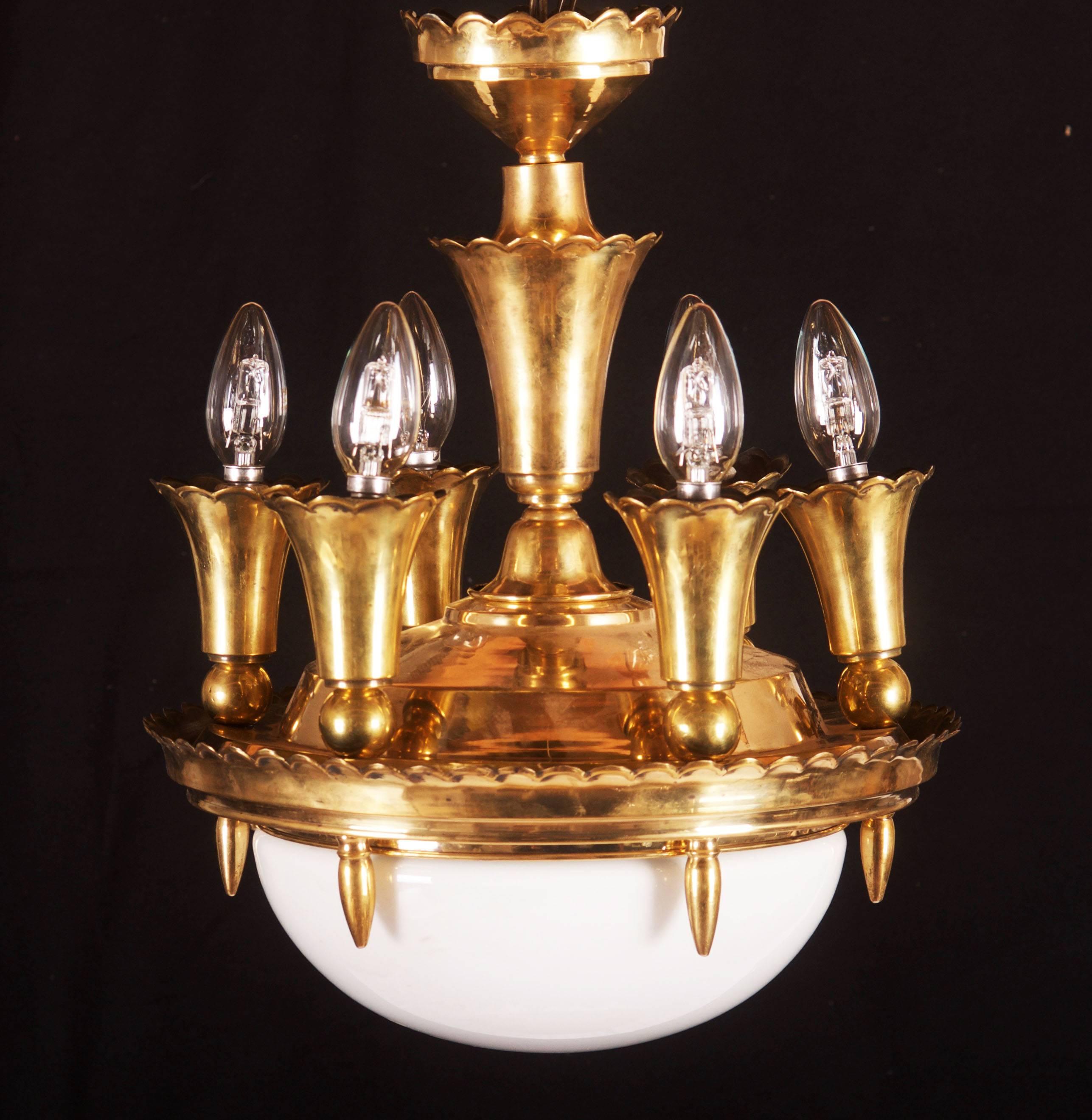 Art Deco or Cubistic chandelier from the 1920s. 
Brass construction with seven E14 sockets and large opaline glass. Restored with new electric.
