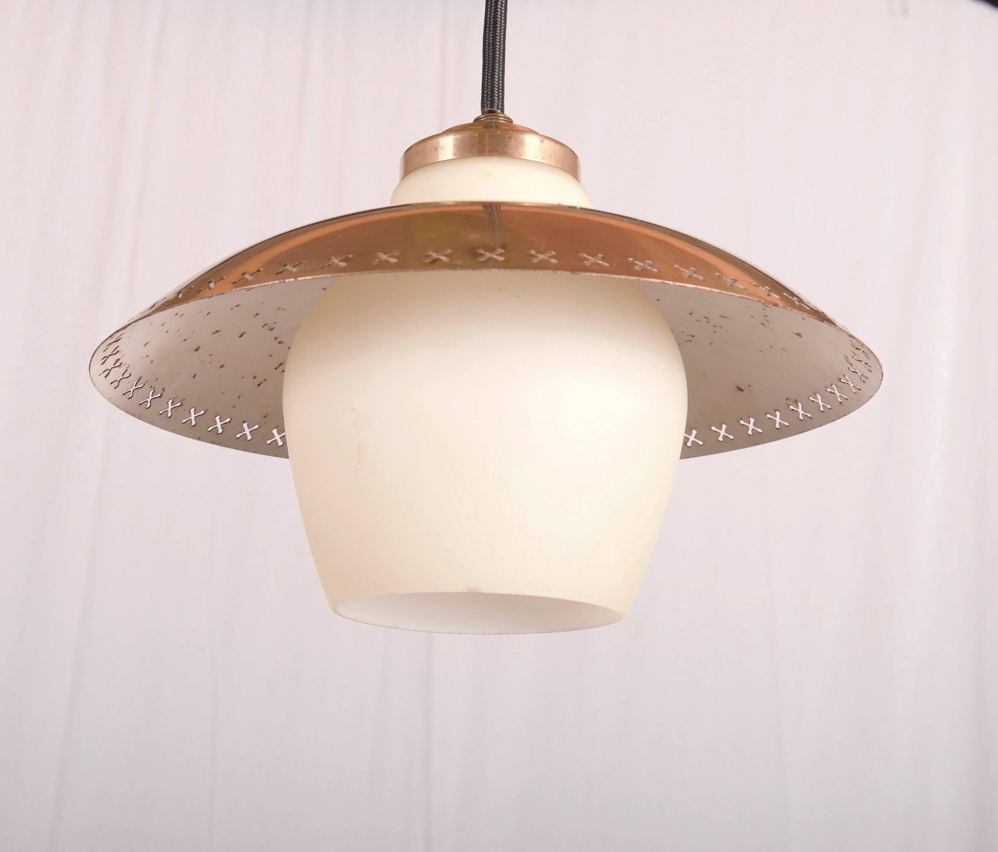 Opaline glass shade with brass element, fitted with one E27 socket.
Designed by Bent Karlby and made by Fog & Mørup in the 1950s.