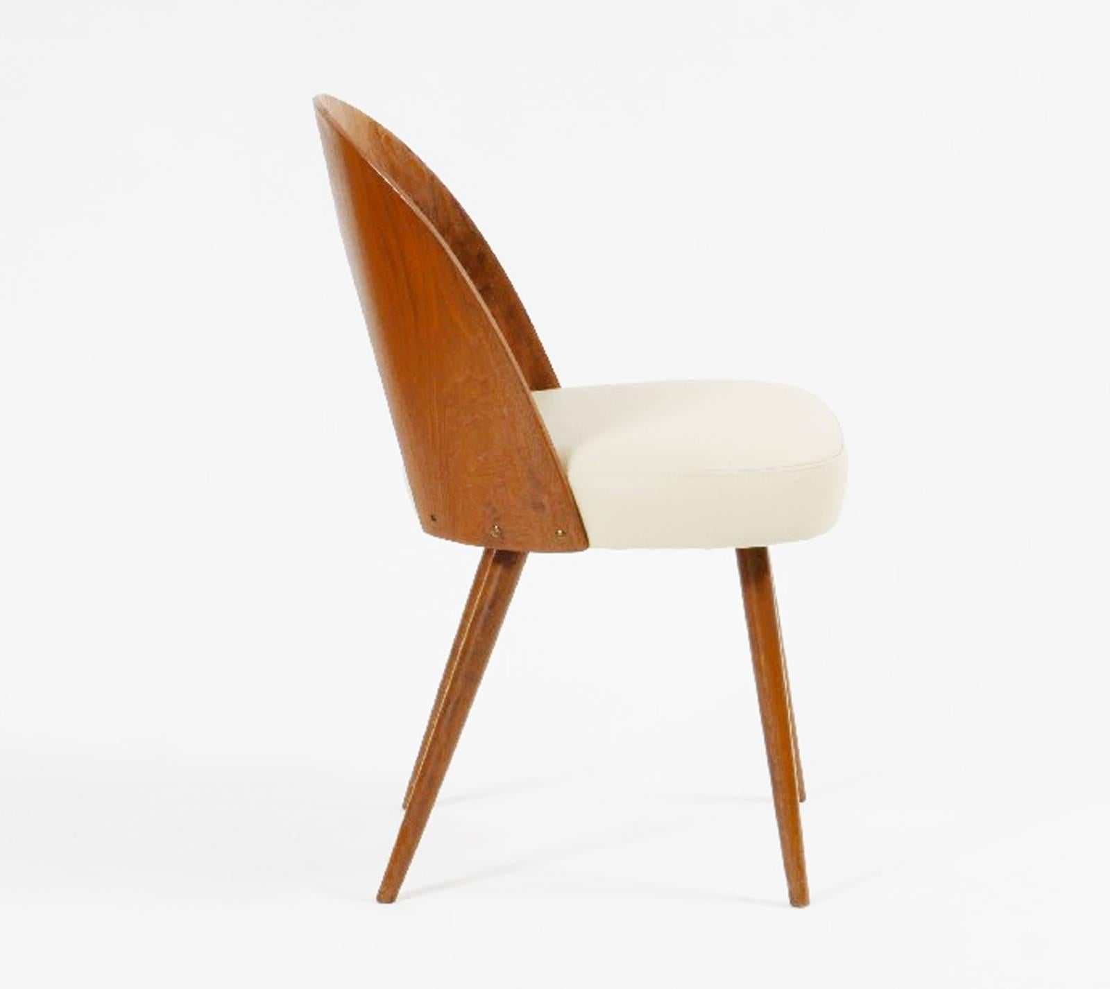 Walnut wood with walnut veneer, upholstered with leather. Designed by Antonin Suman in the 1960s for Tatra in Czechoslovakia. Final color of the leather and the wood can be customized
Up to 24 pieces available, delivery 3-4 weeks.
         