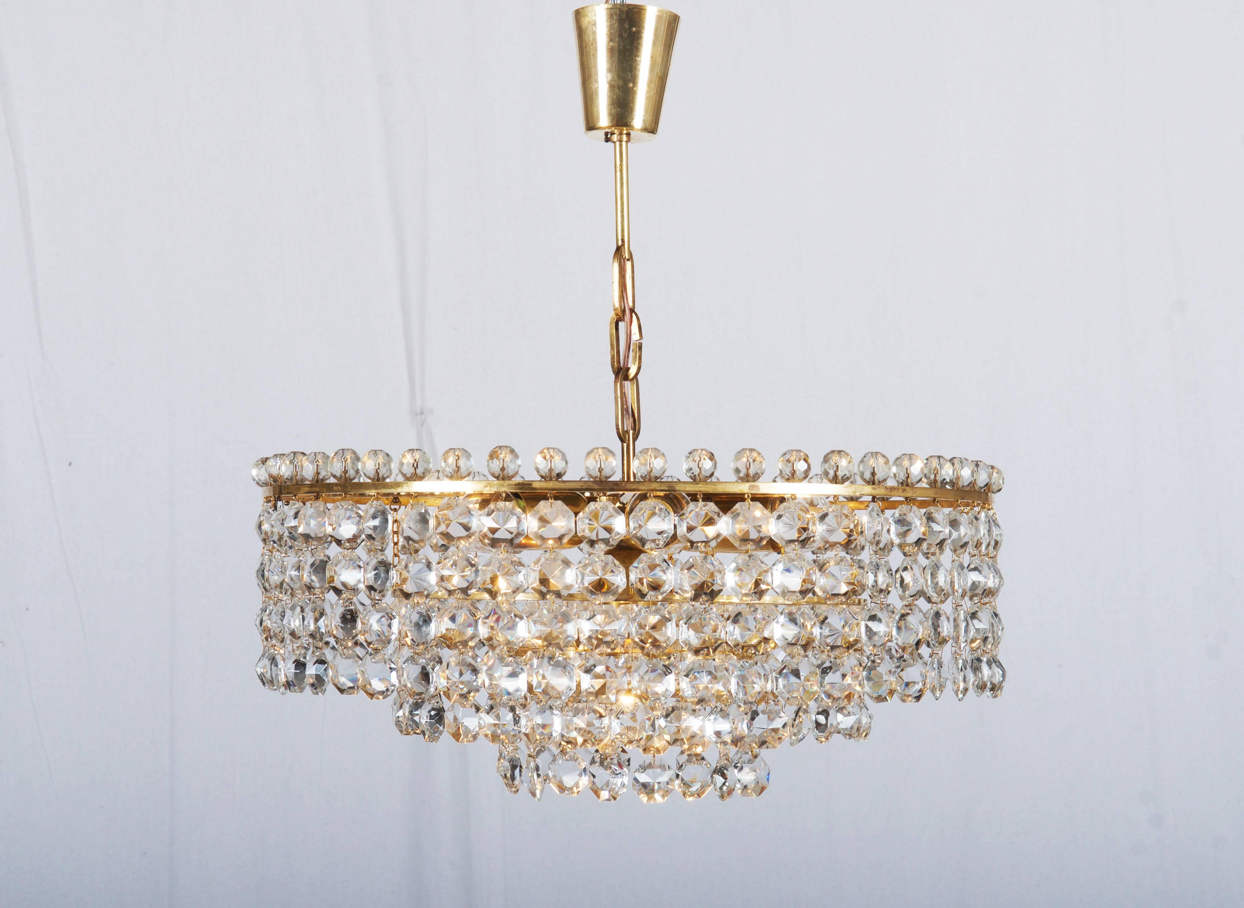 Three layers brass construction with cut crystal elements (octagons and pearls) fitted with seven E27sockets up to 60 watts each.
Made in Vienna in the 1960s by J.L. Lobmeyr.
Dimension of the chandelier only is: diameter 51 cm (20