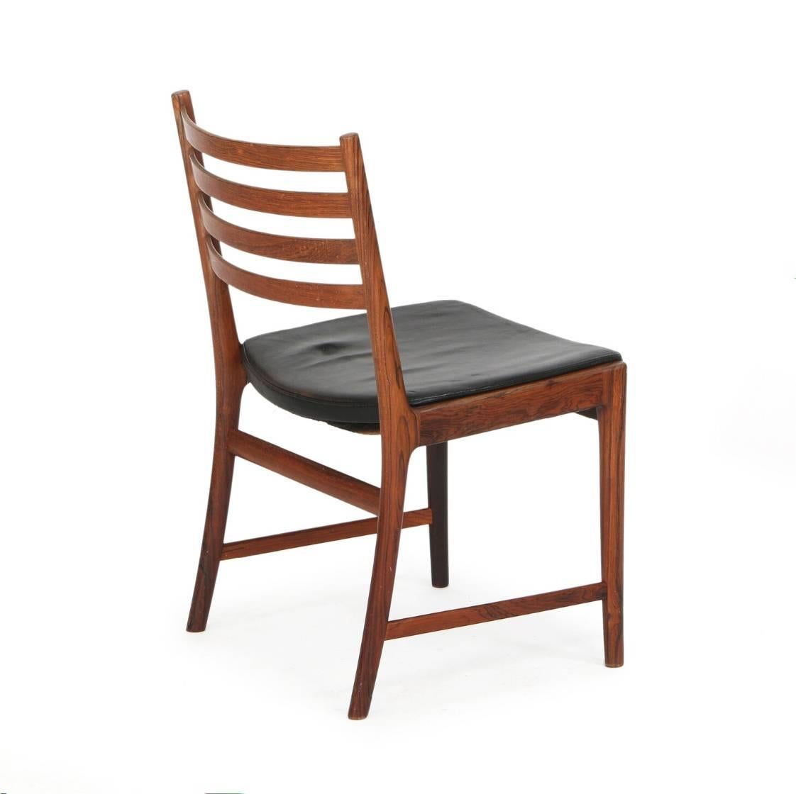 Set of six dining chairs of hardwood. Seats upholstered with black leather. Made by Søren Willadsen in Denmark in the 1960s.
Wear due to age and use.
  