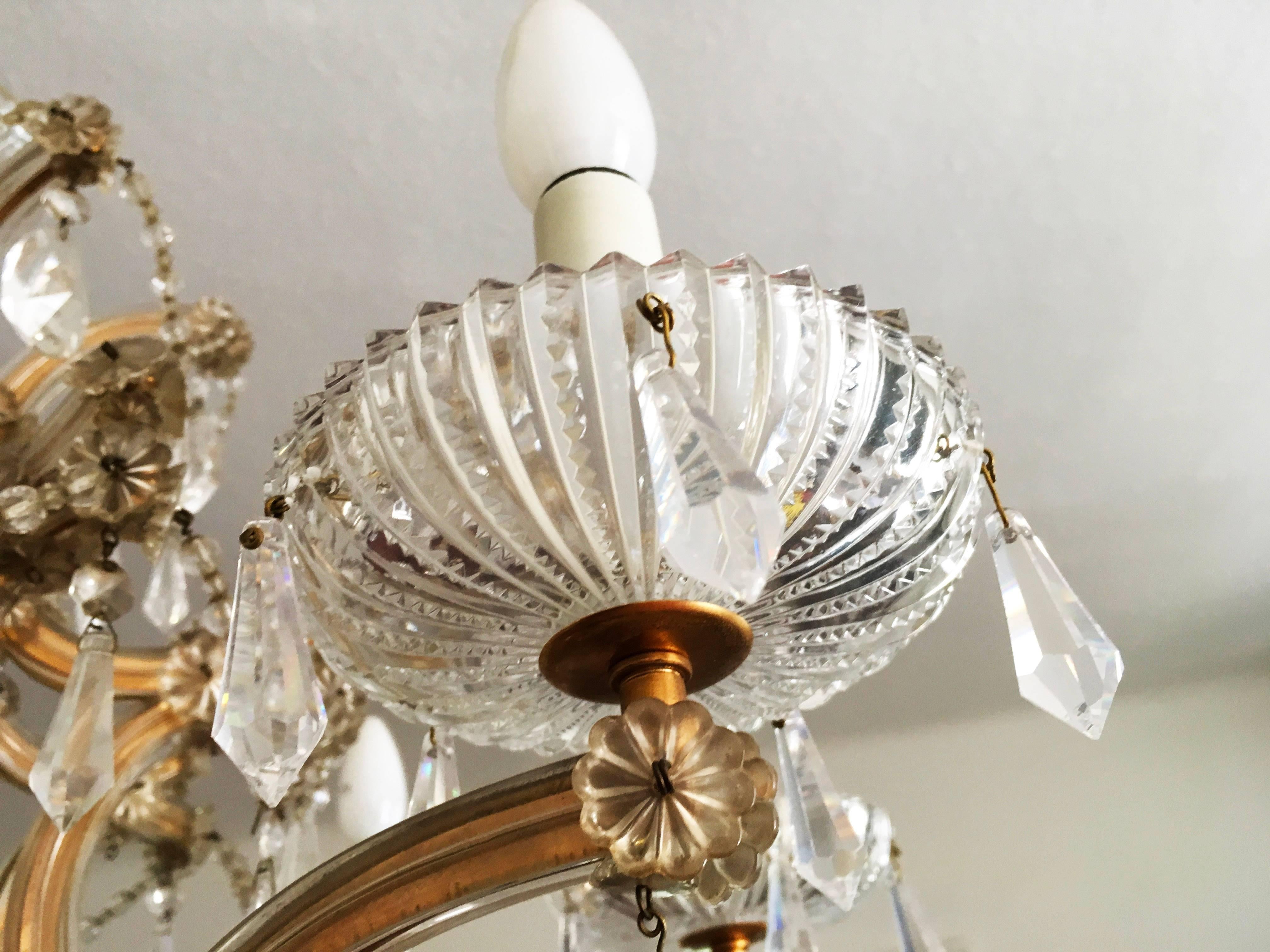 Brass/cut crystal chandelier in Maria Theresia style made in the 1960s probably by Lobmeyr in Vienna.
A beautiful form body. Eight flamed fitted with E14 sockets, rich hangings from the various faceted crystal.