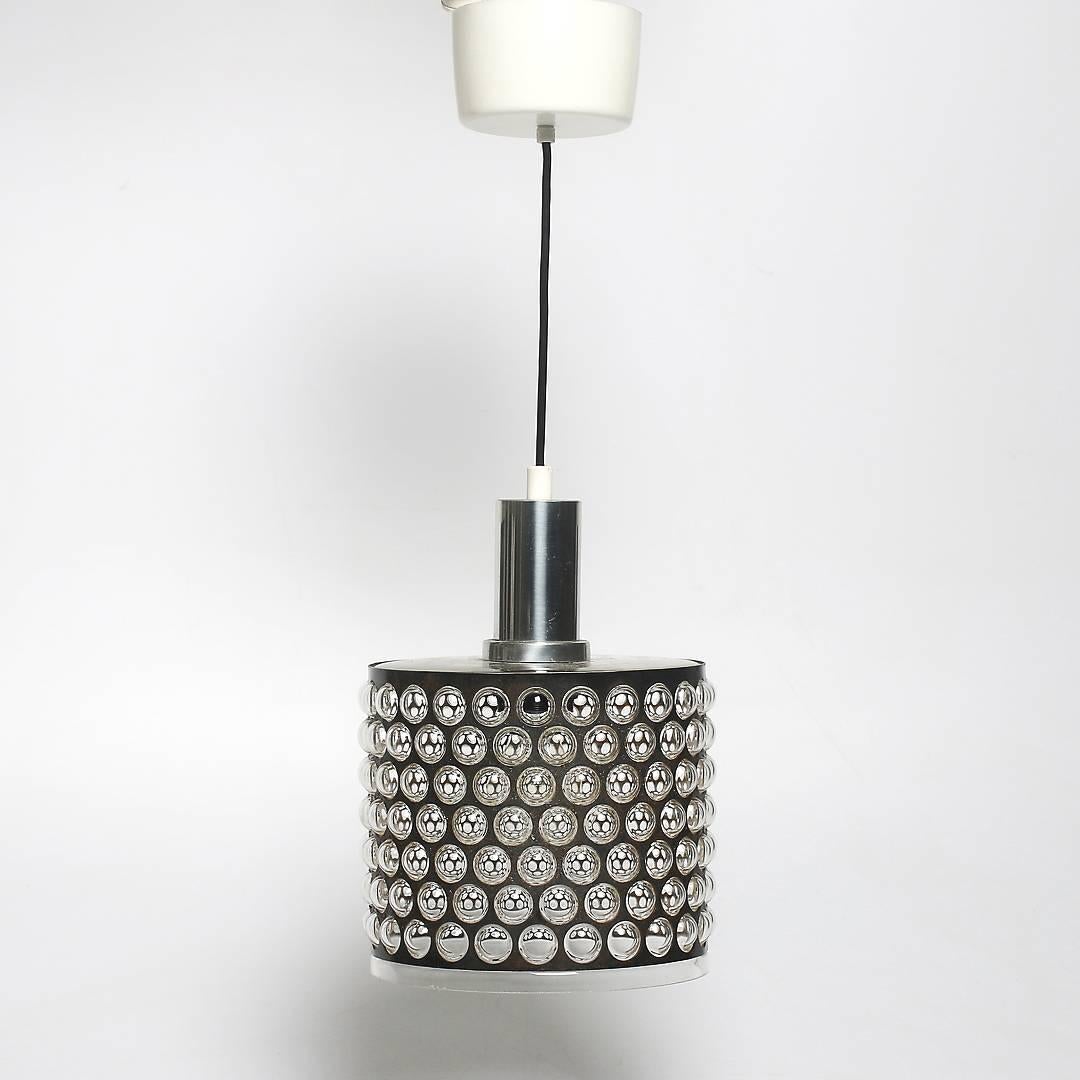 The glass shade is blown in a perforated steel tube/ring. Fitted with one E27 socket. Made in Sweden in the 1950s.
Dimension of the shade only: diameter 21cm (8.2"), height 27cm (11")
Total length will be customized.

 
