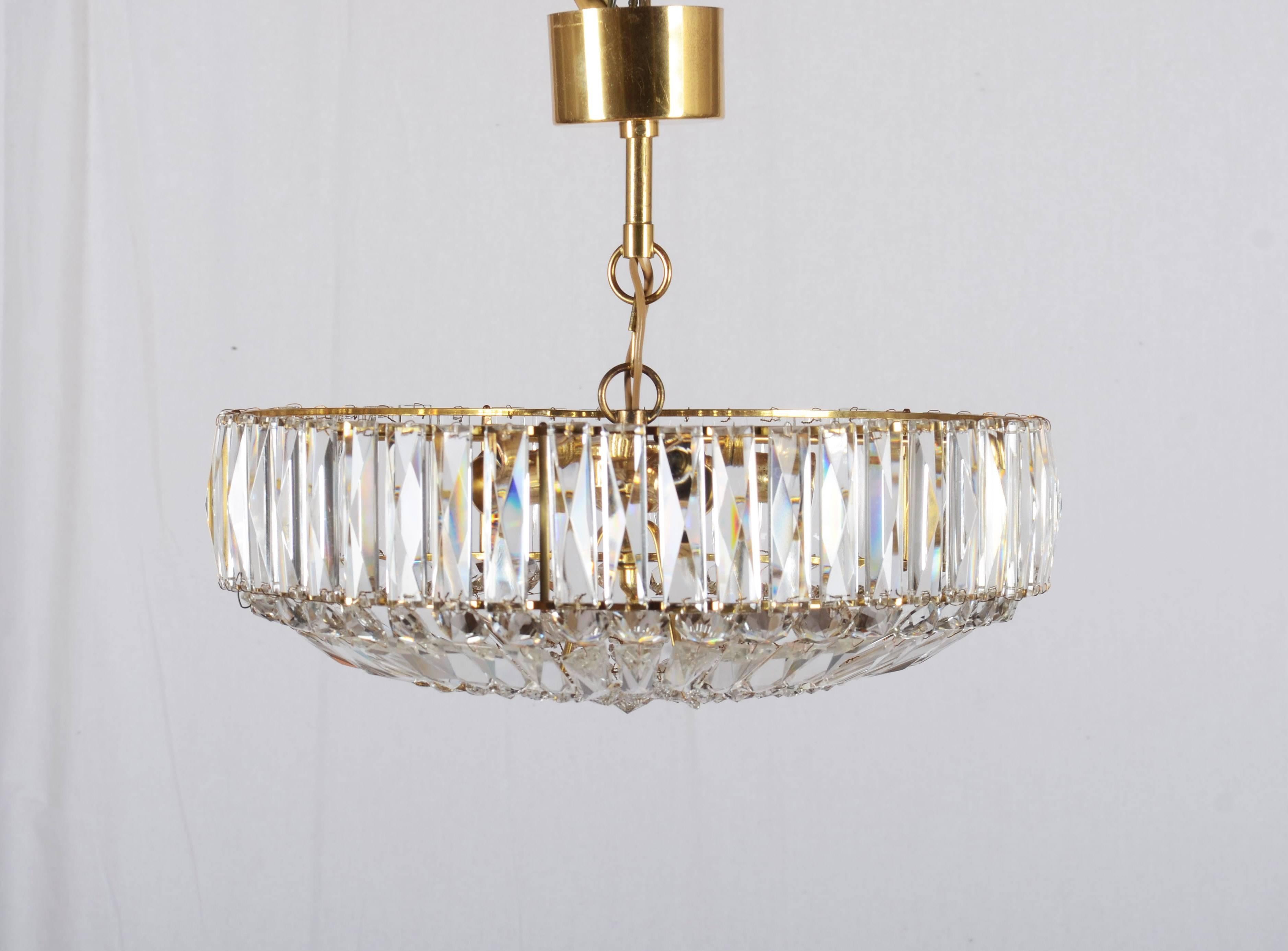 Brass frame with cut crystal elements. Fitted with five E14 sockets. Made in Sweden probably in the 1960s.